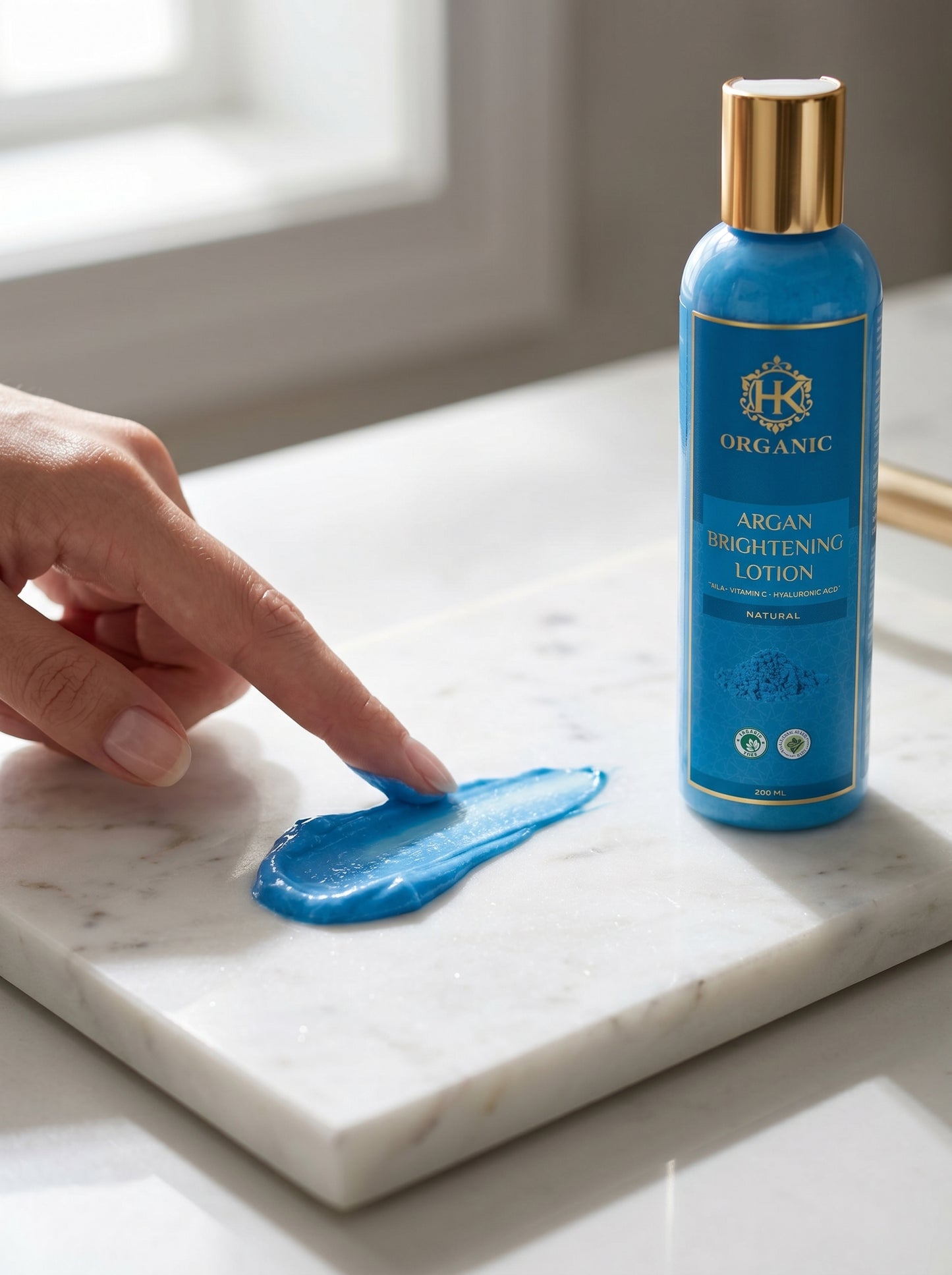 Blue lotion bottle with a sample on a marble surface