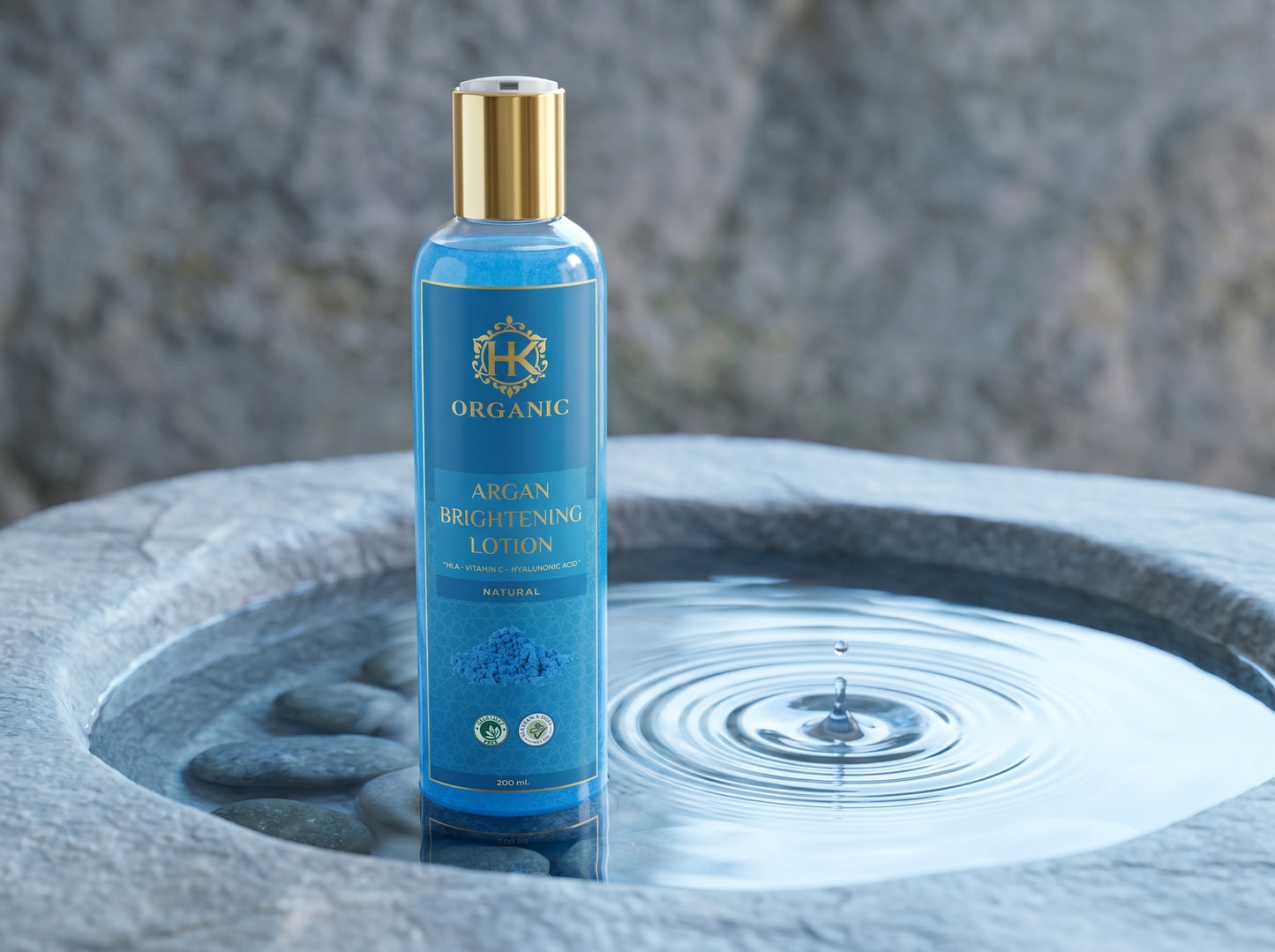 Blue bottle with gold cap on a stone surface with water ripples