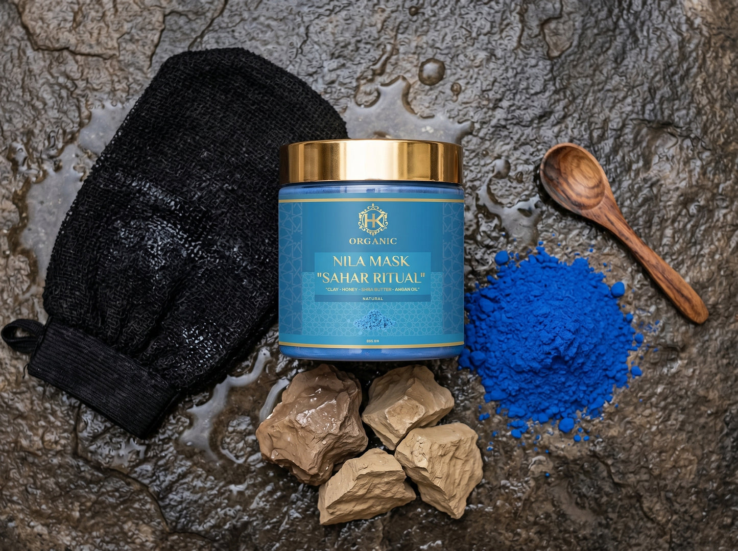 Nila Mask 'Sahar Ritual' jar with black mask mitt, blue powder, and wooden spoon on a textured surface