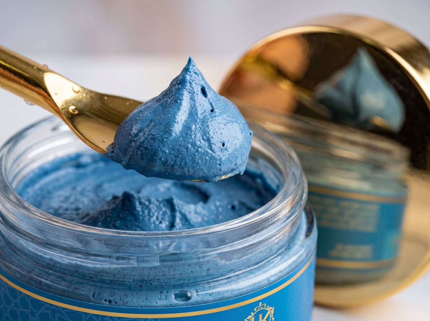 Blue cream in a jar with a gold spoon