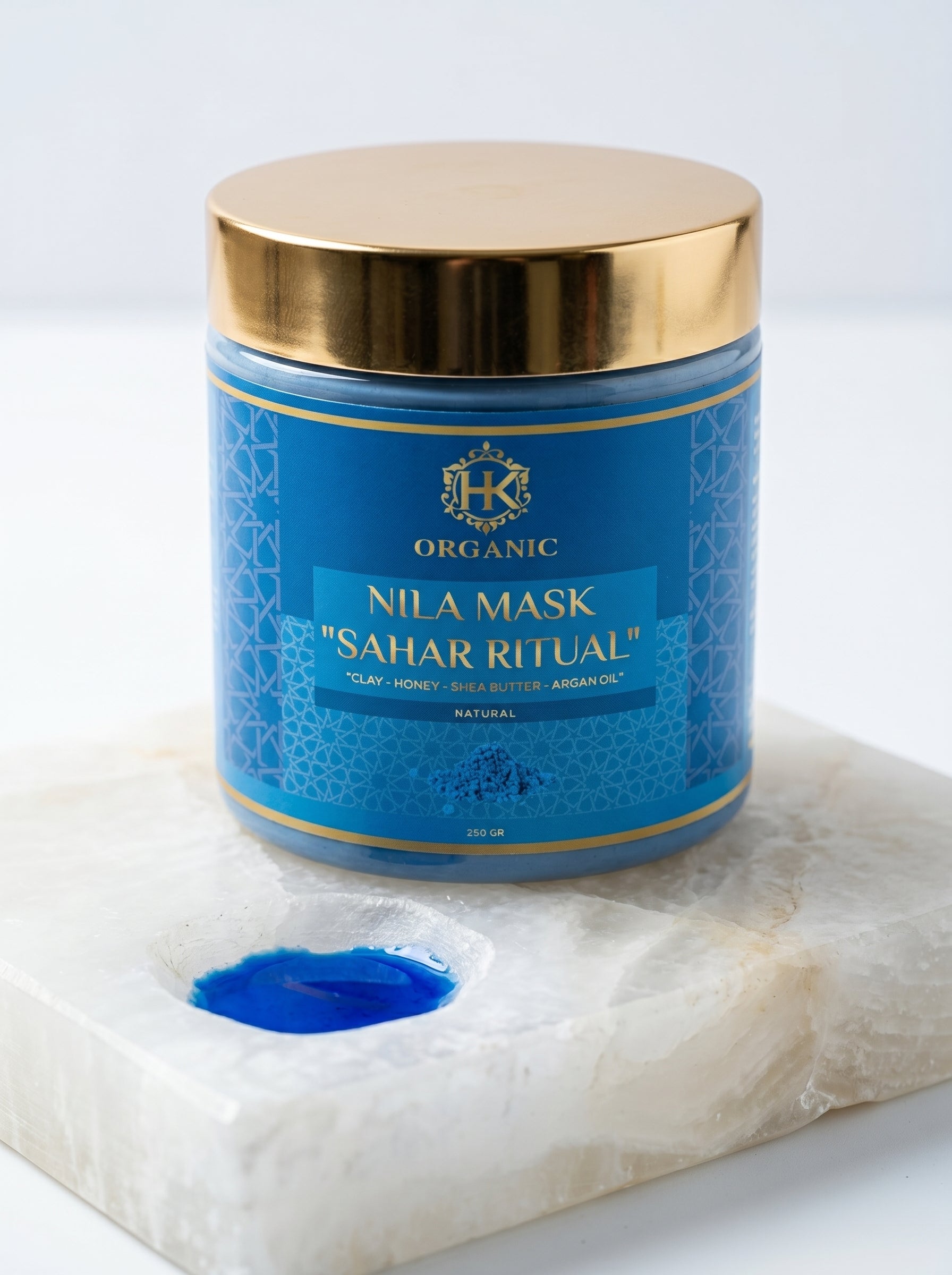Blue jar of Nila Mask Sahar Ritual on a marble surface with a white background