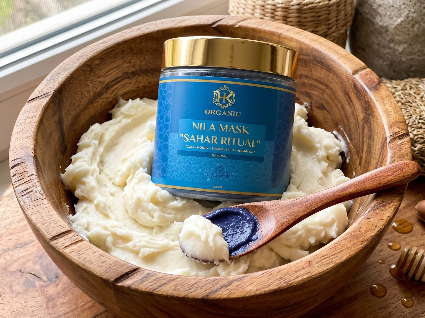 Jar of 'Nila Mask Sahar Ritual' organic product in a wooden bowl with a spoonful of cream.
