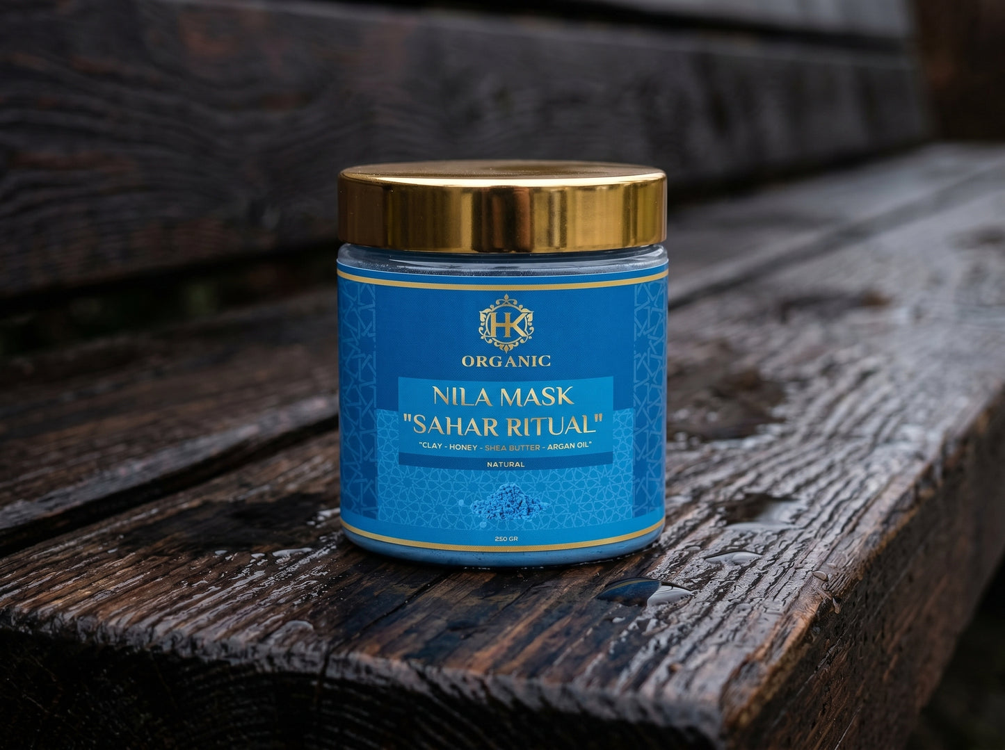 Blue jar with gold lid on a wooden surface