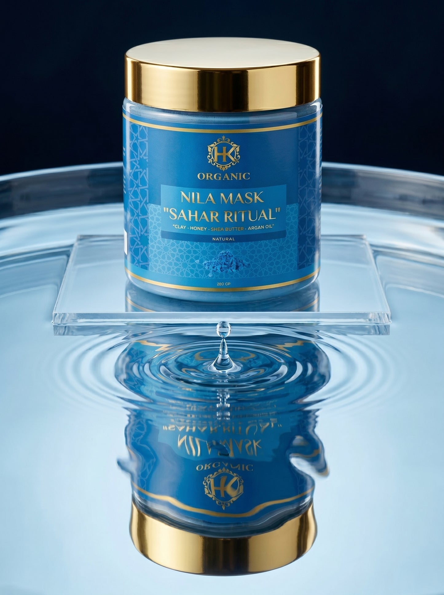 Blue jar with gold lid labeled 'Nila Mask Sahar Ritual' on a reflective surface.