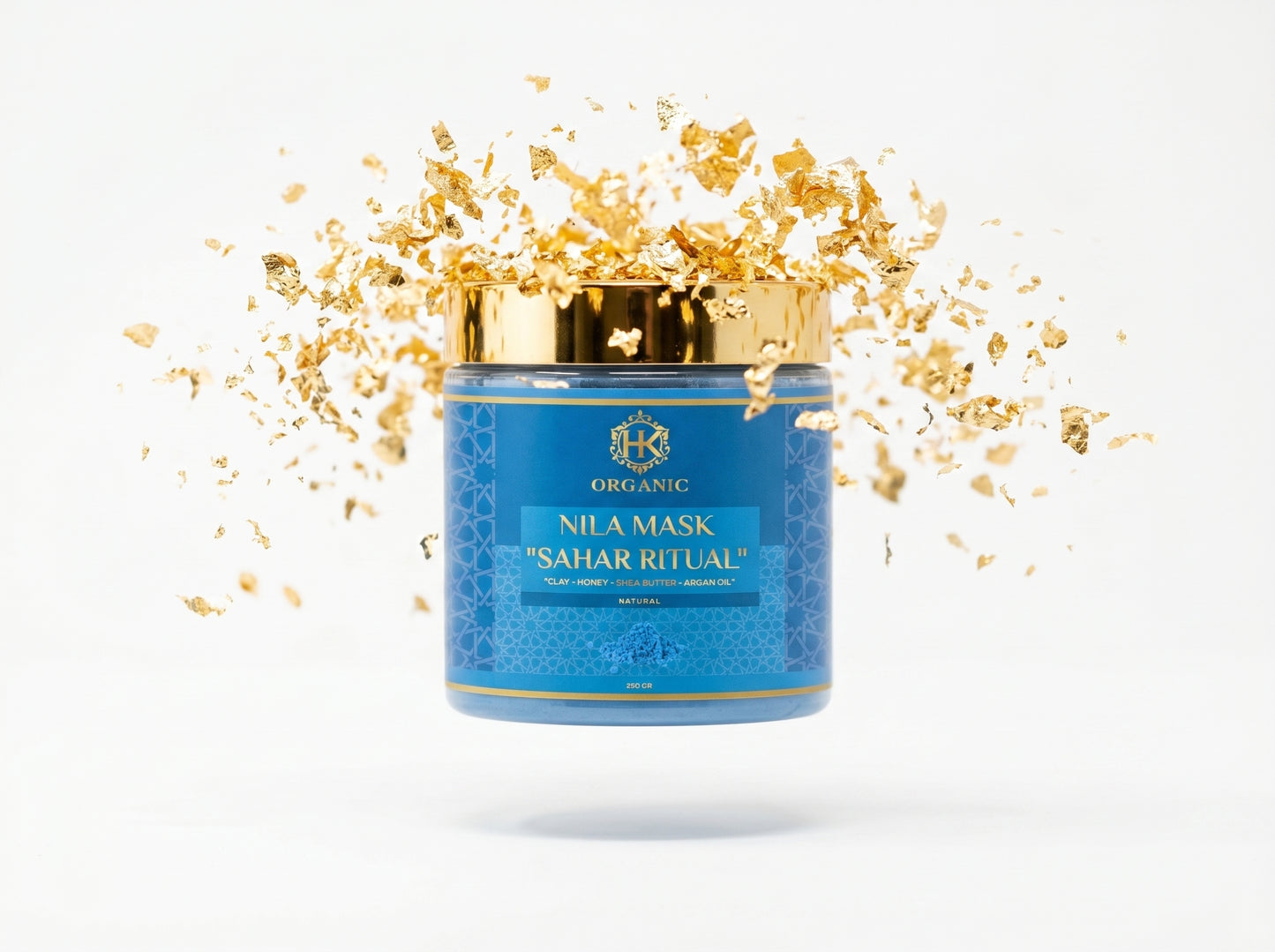 Blue jar of Nila Mask with gold flakes on a white background