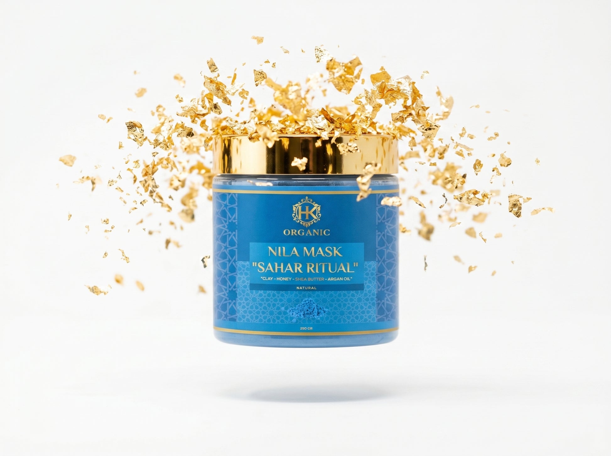 Blue jar of Nila Mask with gold flakes on a white background