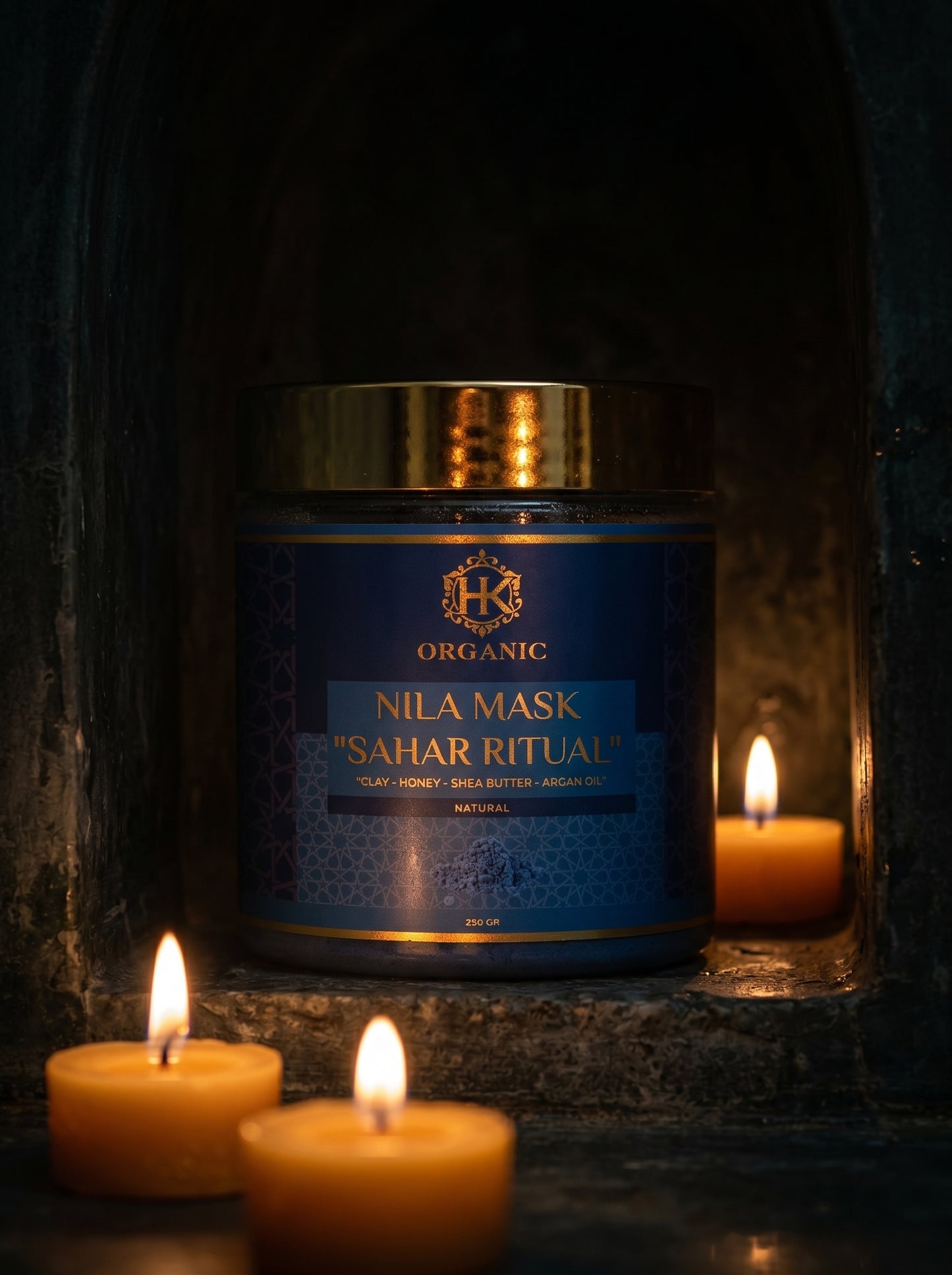 Jar of Nila Mask Sahar Ritual organic mask with candles on a dark background