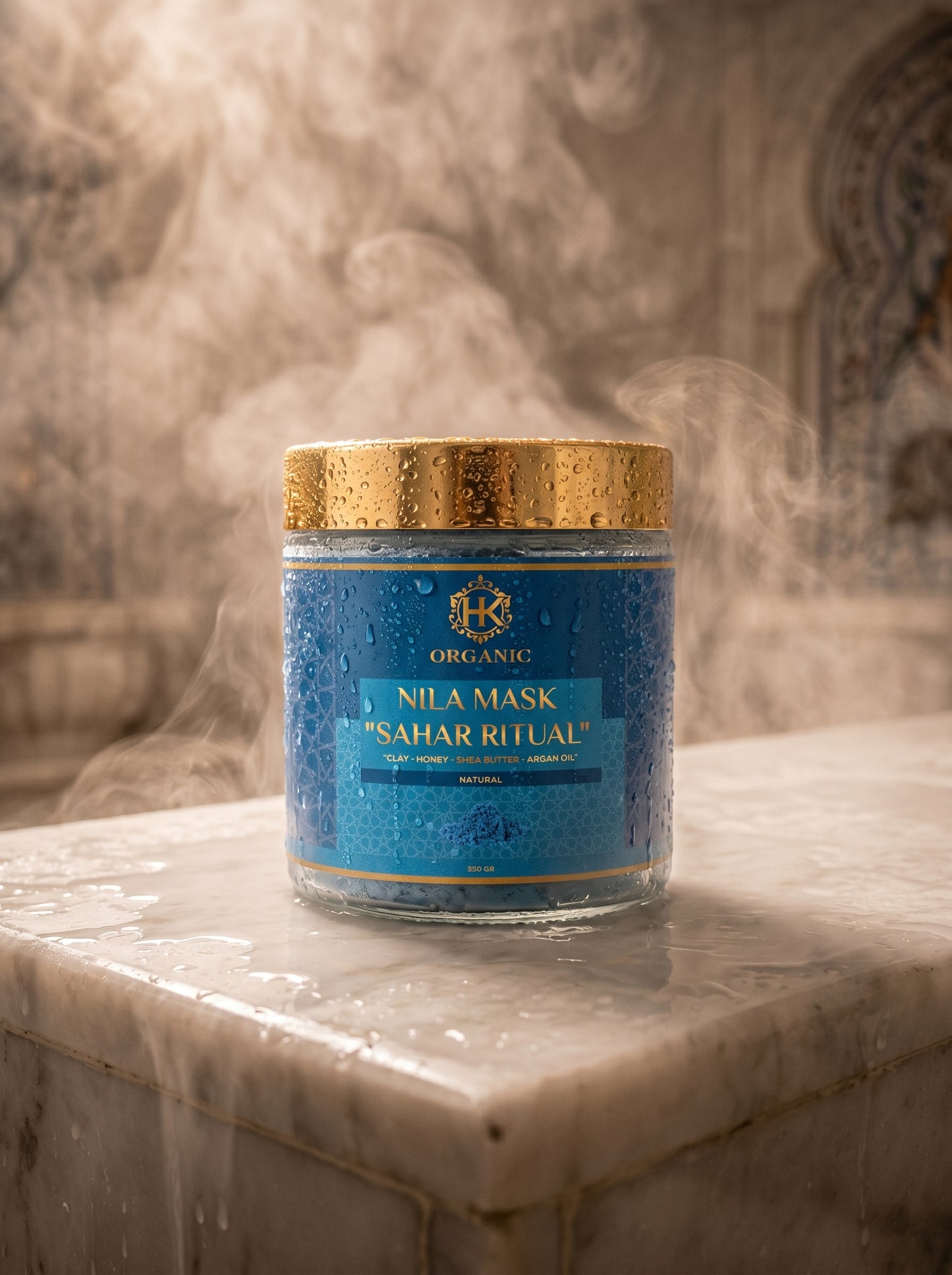 Blue jar with gold lid labeled 'Nila Mask' on a marble surface with a smoky background
