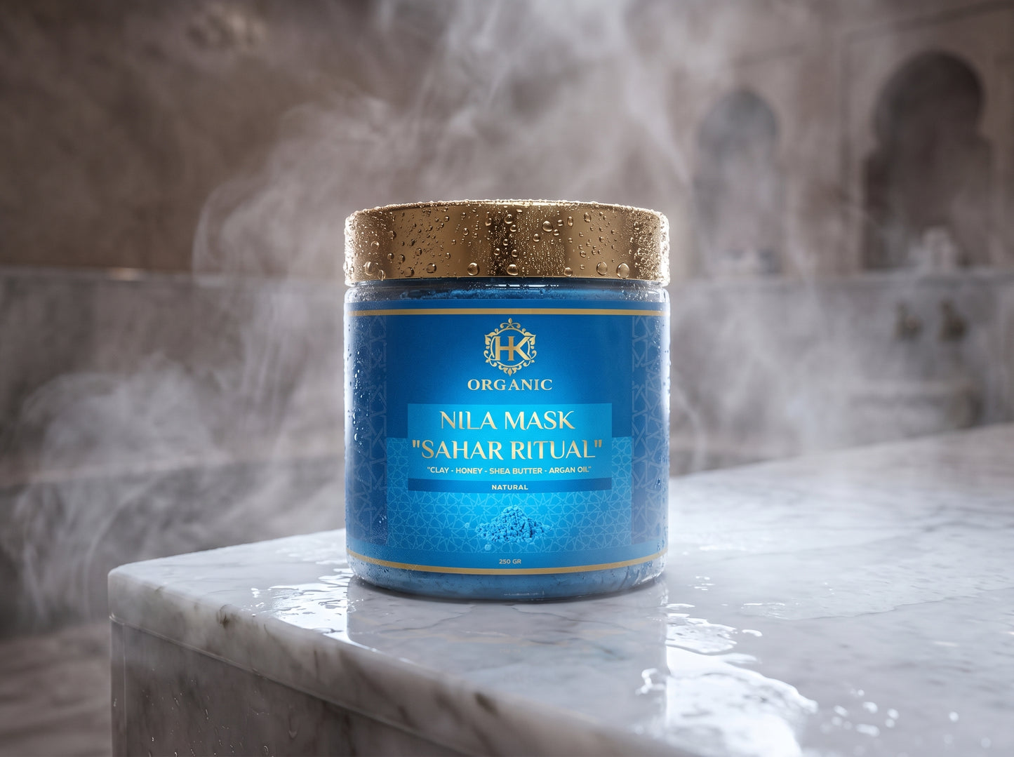 Blue jar of Nila Mask on a marble surface with a textured wall background