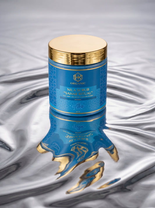 Blue and gold cosmetic container with intricate design on a textured gray background