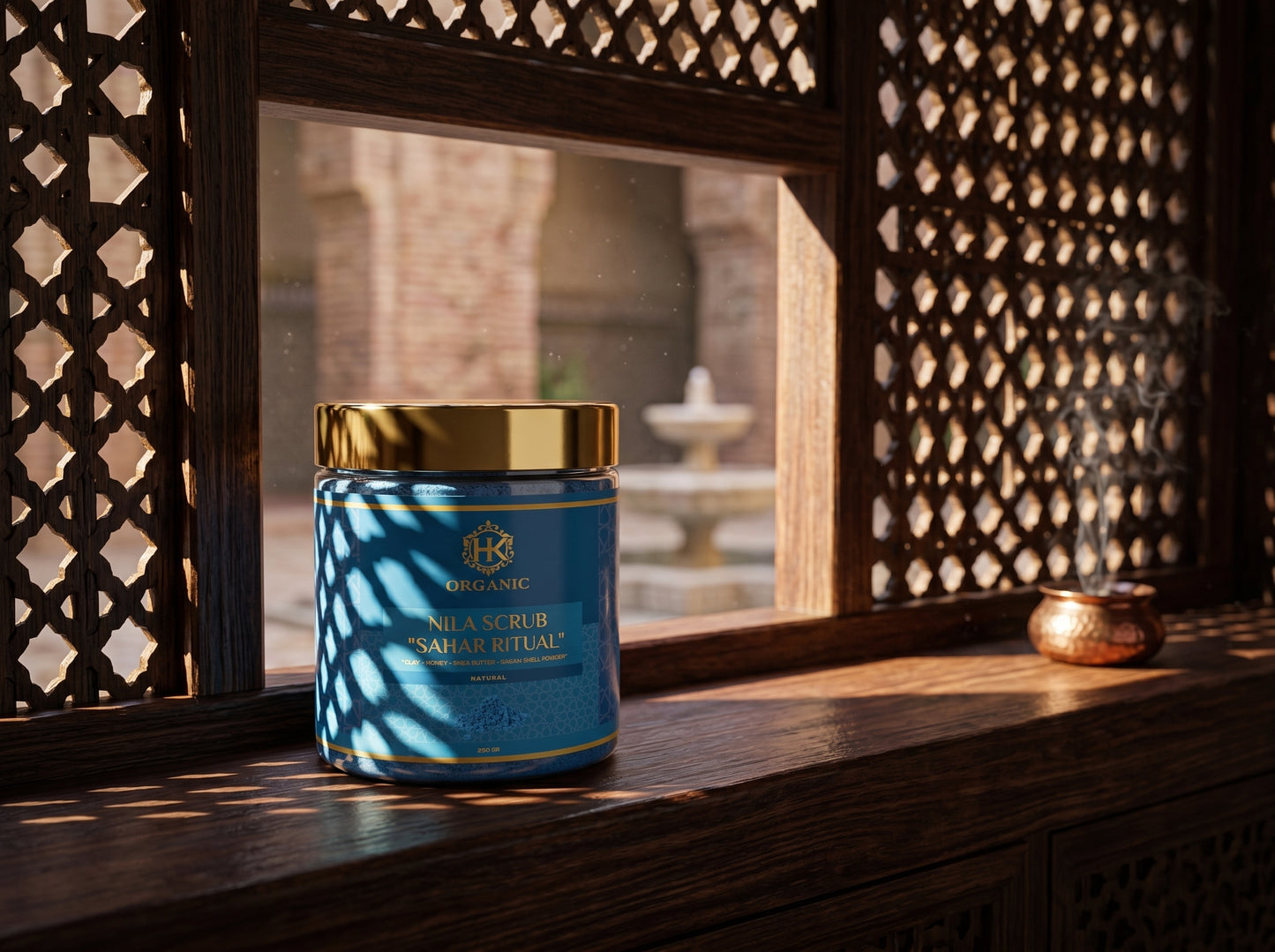 Blue jar with gold lid on a wooden surface with a decorative window in the background