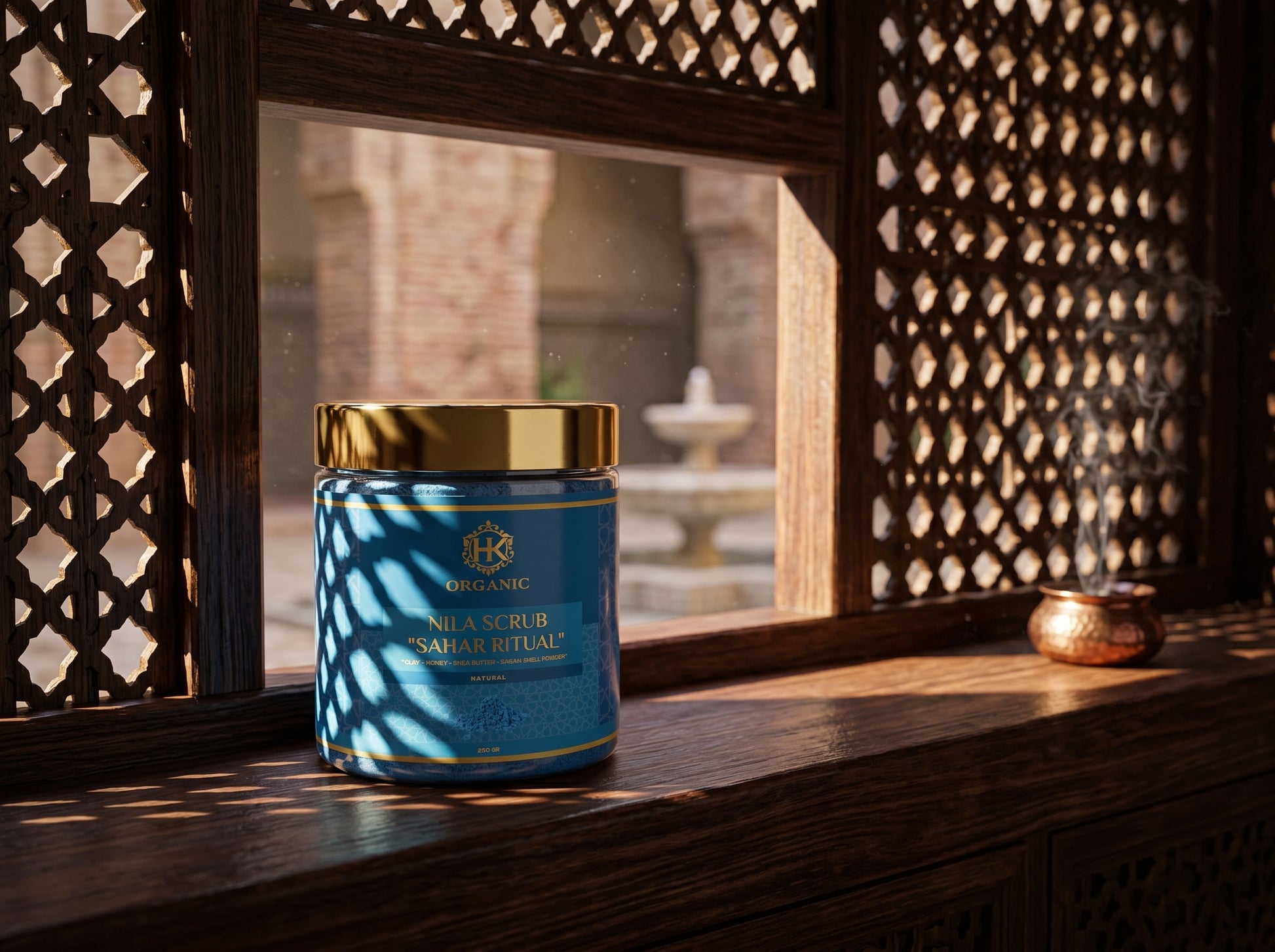 Blue jar with gold lid on a wooden surface with a decorative window in the background