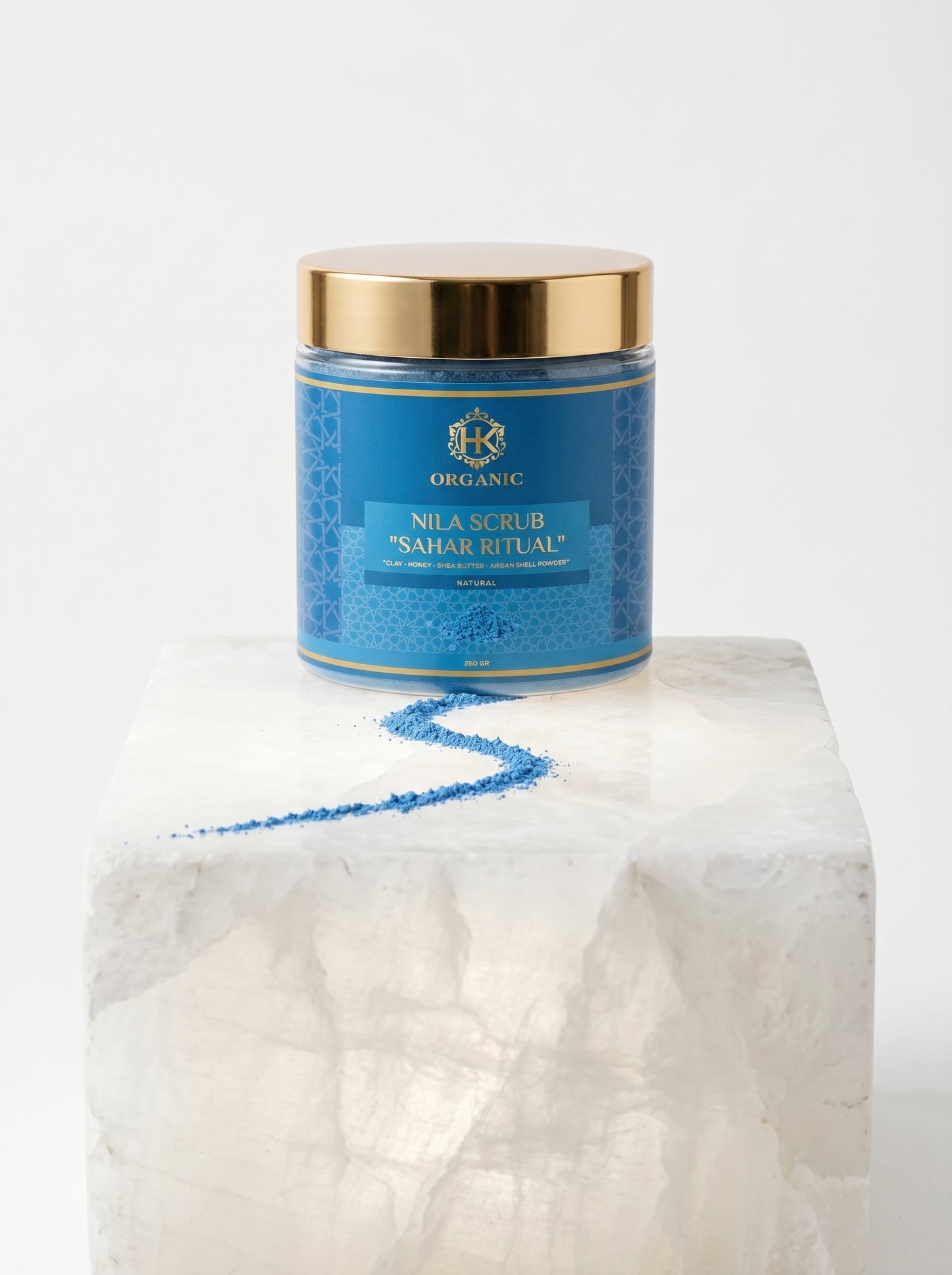 Blue jar with gold lid on a white marble surface