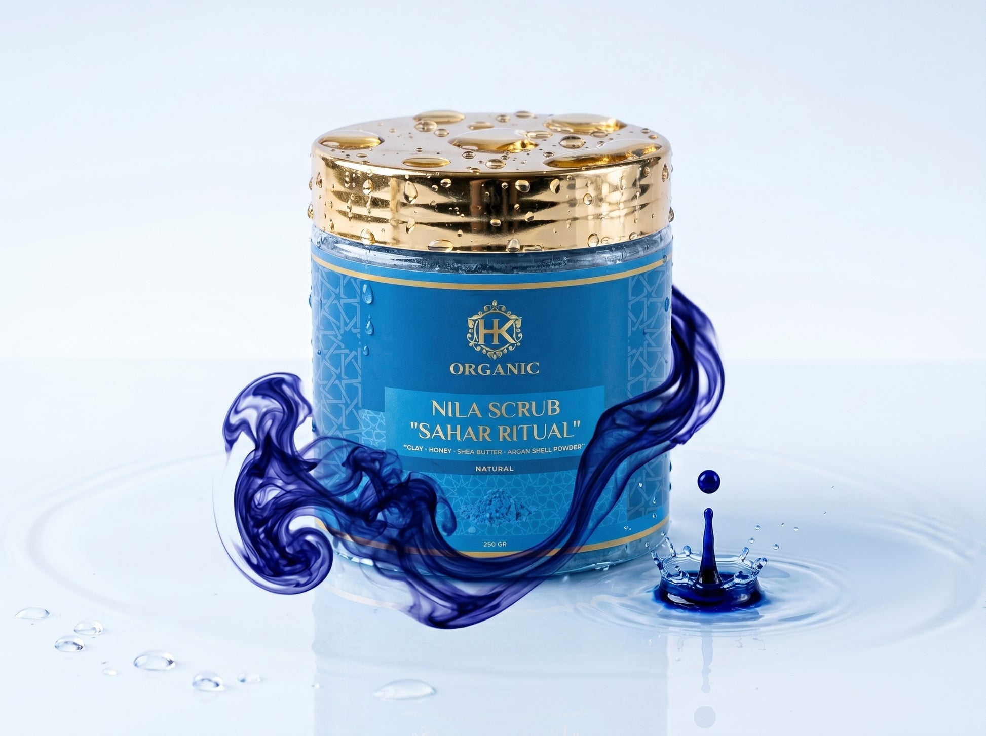 Blue jar of Nila Scrub with gold lid on a white background