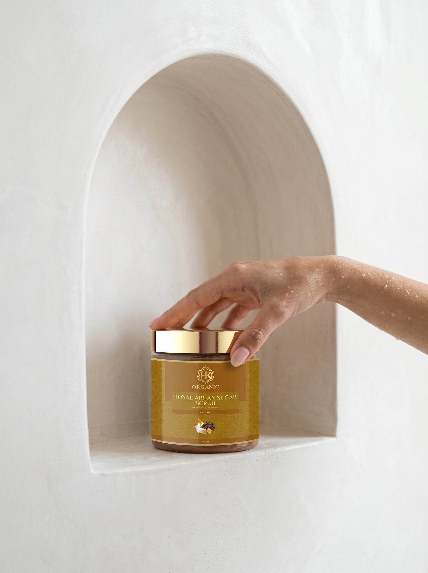Hand reaching for a jar of Royal Jelly on a white background