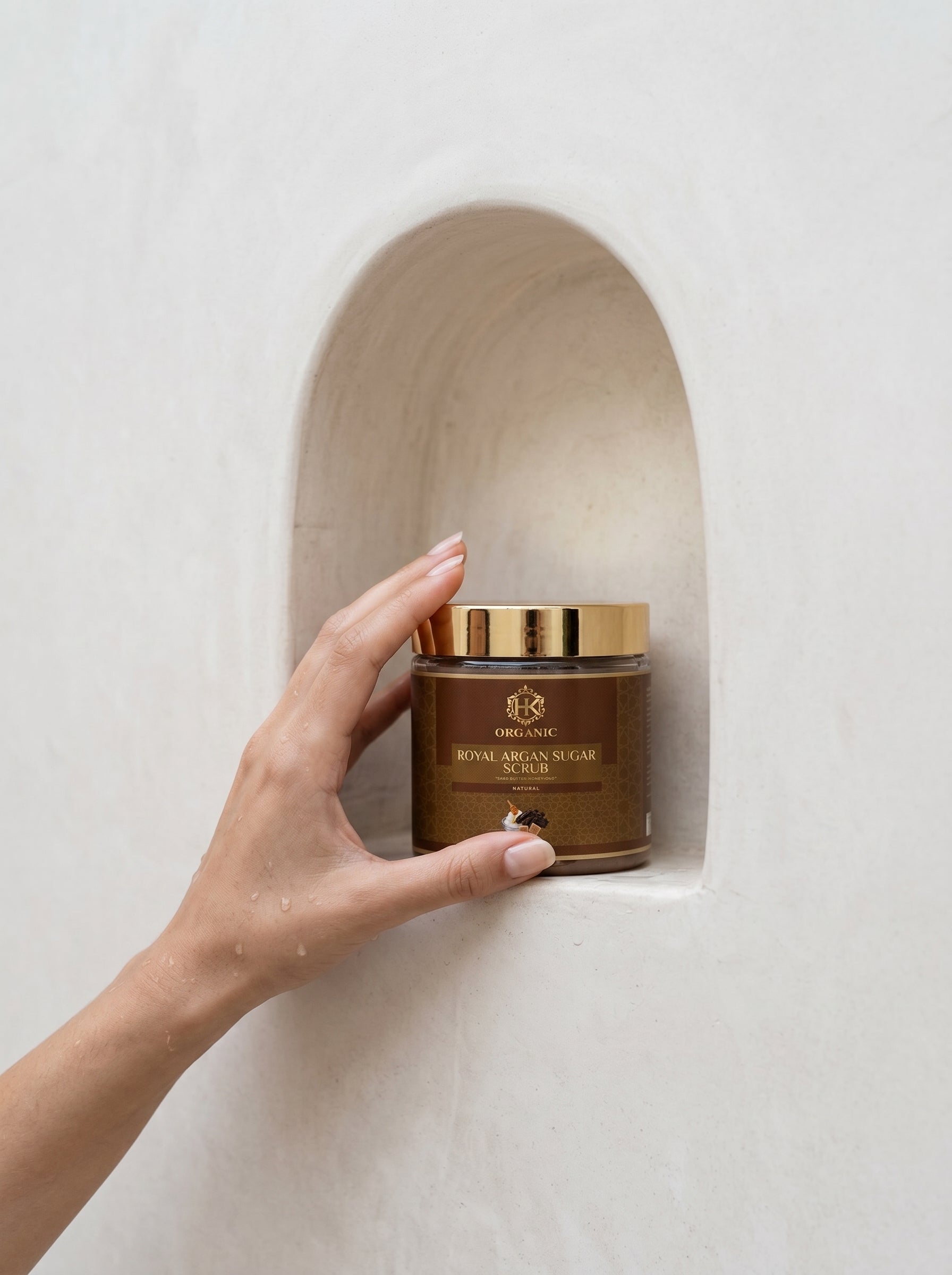 Hand holding a jar of organic against a neutral background