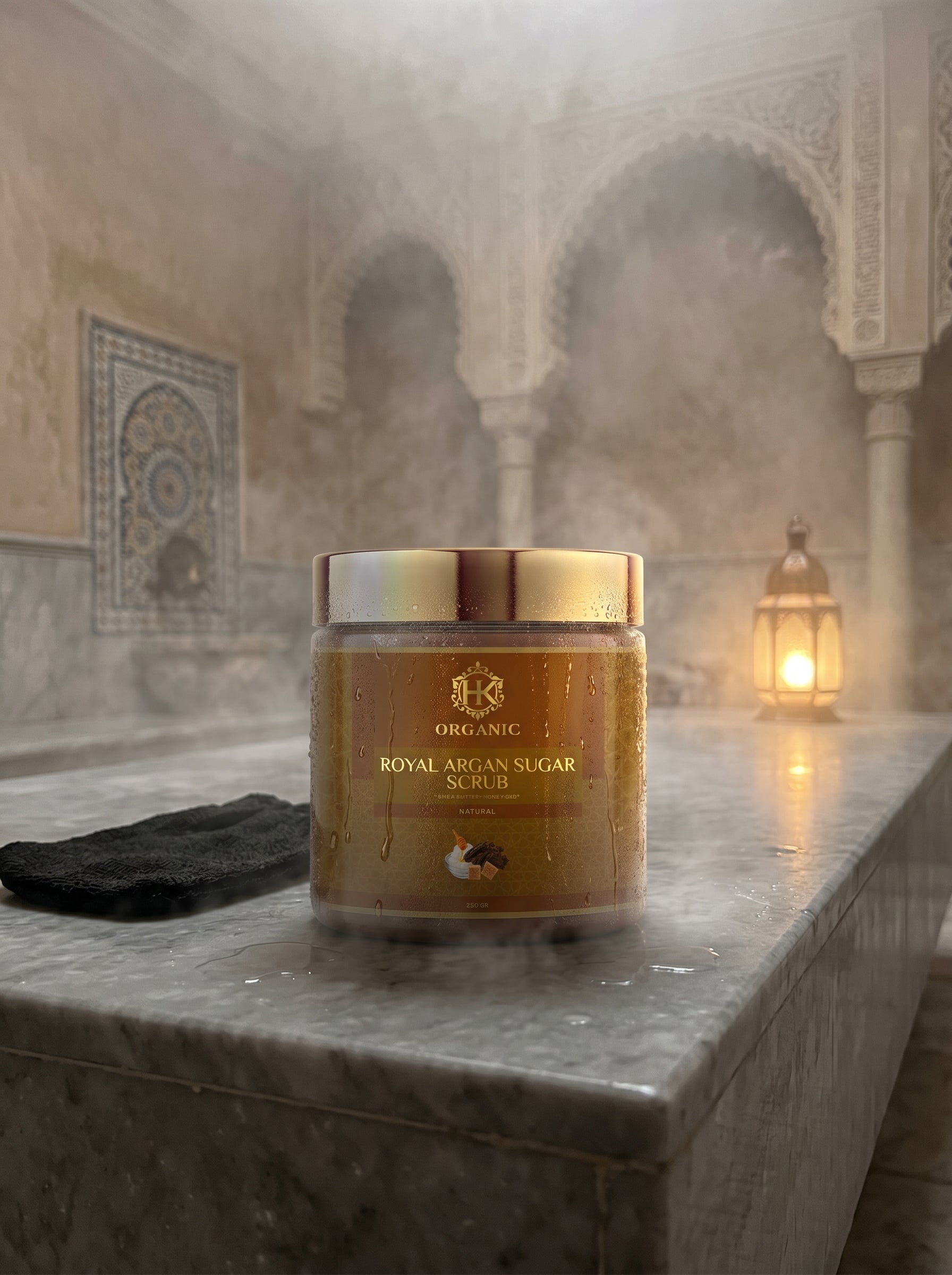 Jar of Royal Argan Sugar Scrub on a marble surface with a blurred background