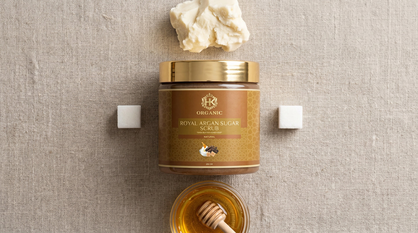 Jar of Royal Argan Sugar Scrub with honey and a honeycomb on a textured beige background