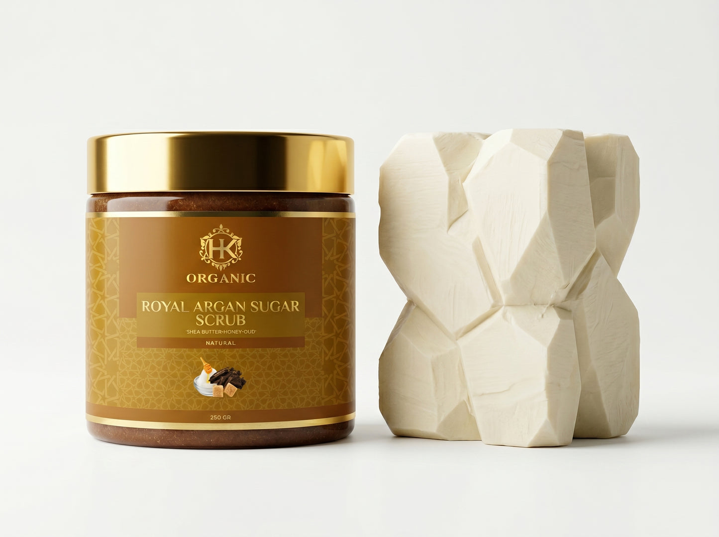 Jar of organic argan sugar scrub with a geometric soap block on a light background