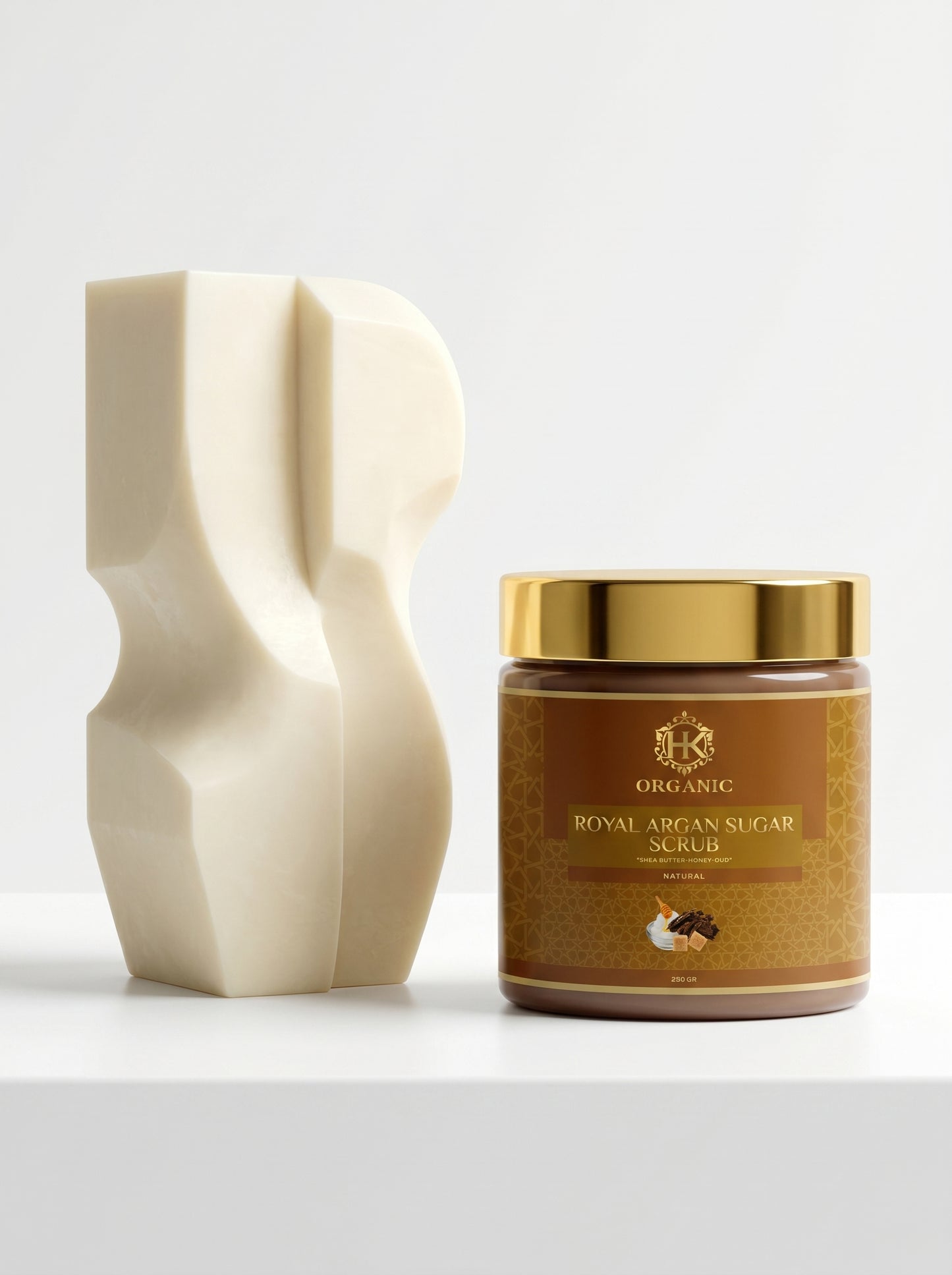 Jar of Royal Argan Sugar with a decorative white container on a light gray background