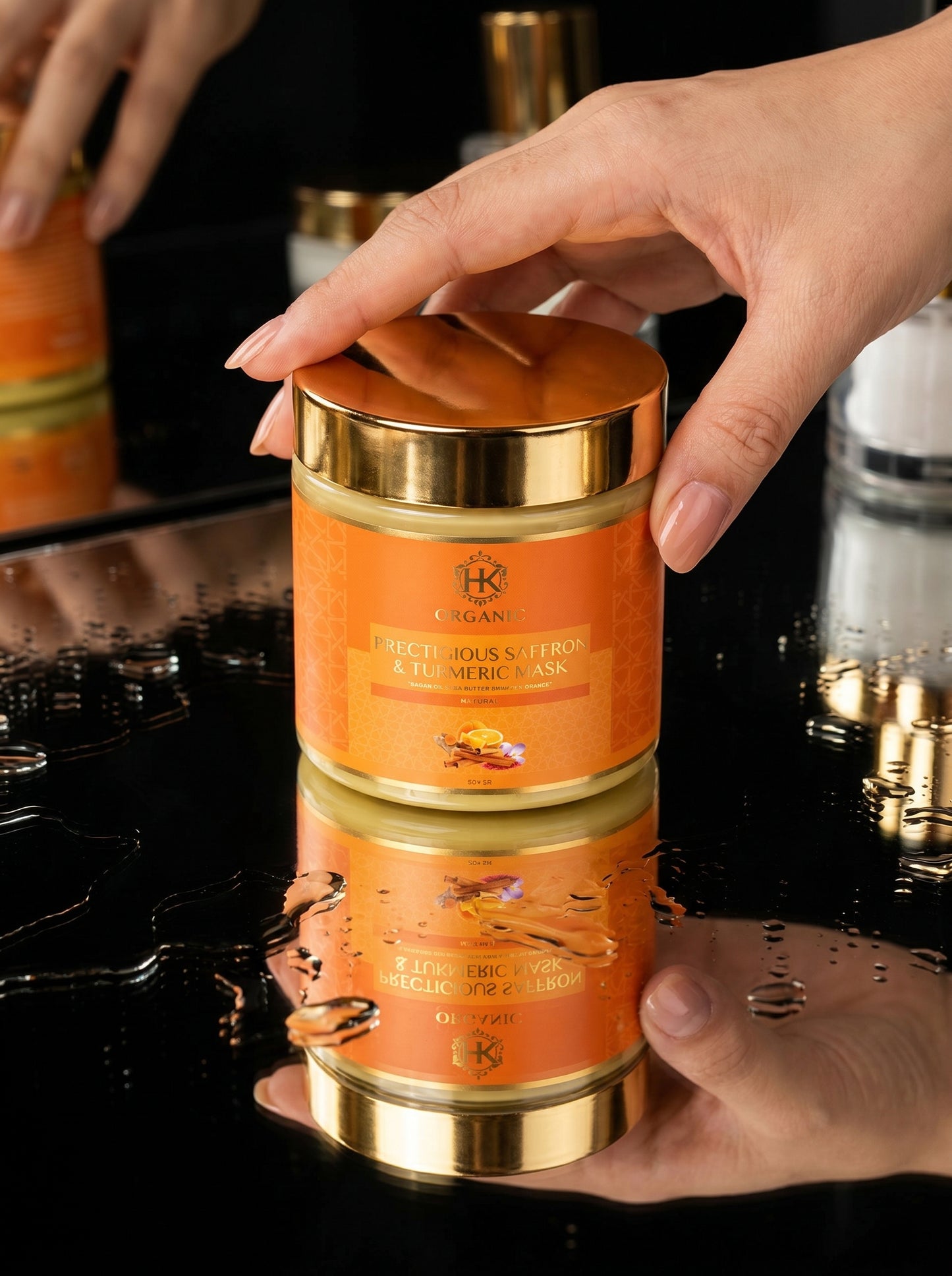 Hand holding a gold and orange container with visible branding on a reflective surface.