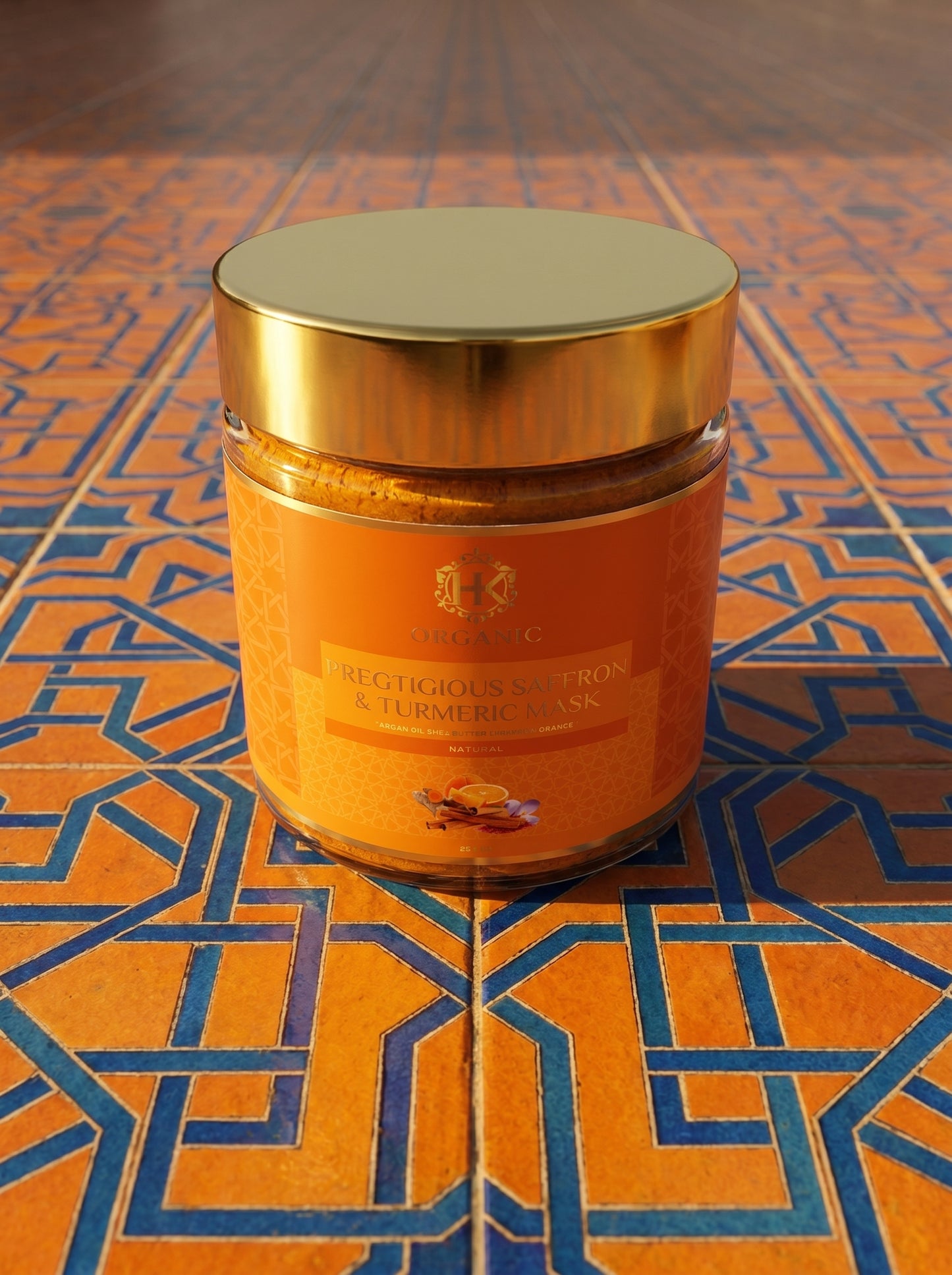 Jar with gold lid on an orange and blue patterned surface