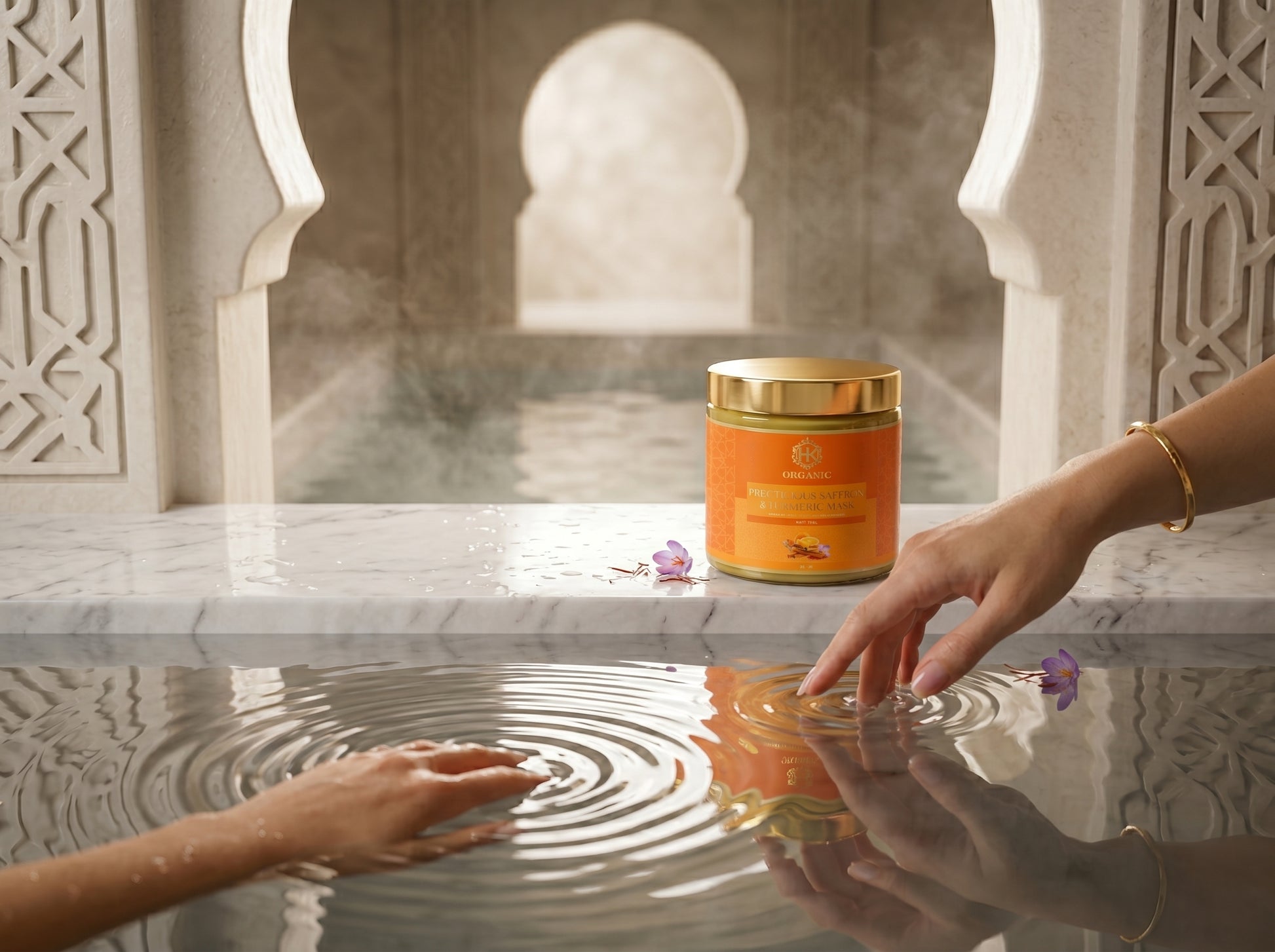 turmeric with gold lid on a marble surface with hands reaching towards it, against an architectural background.