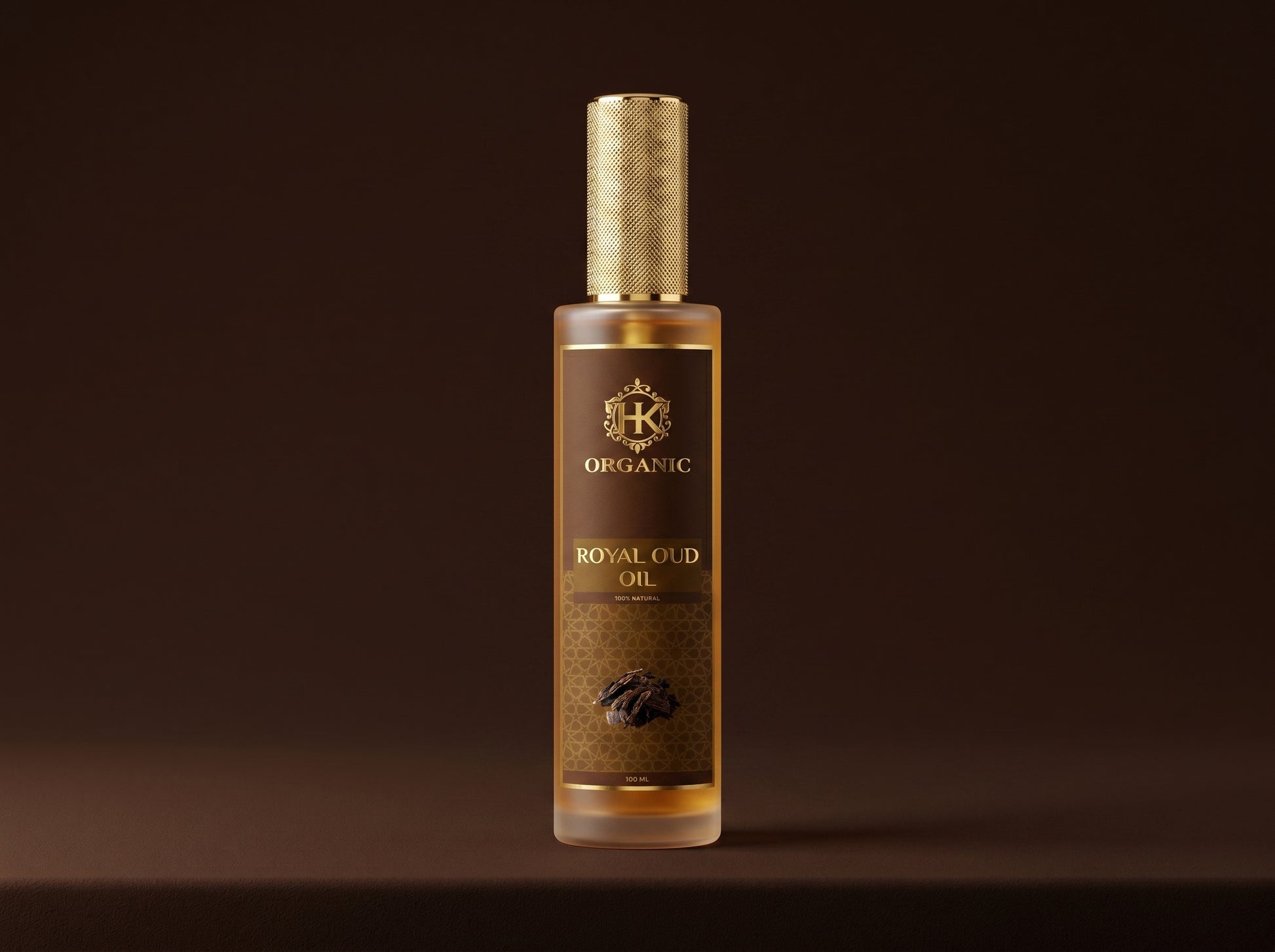 Bottle of organic royal oud oil with a gold cap on a dark background