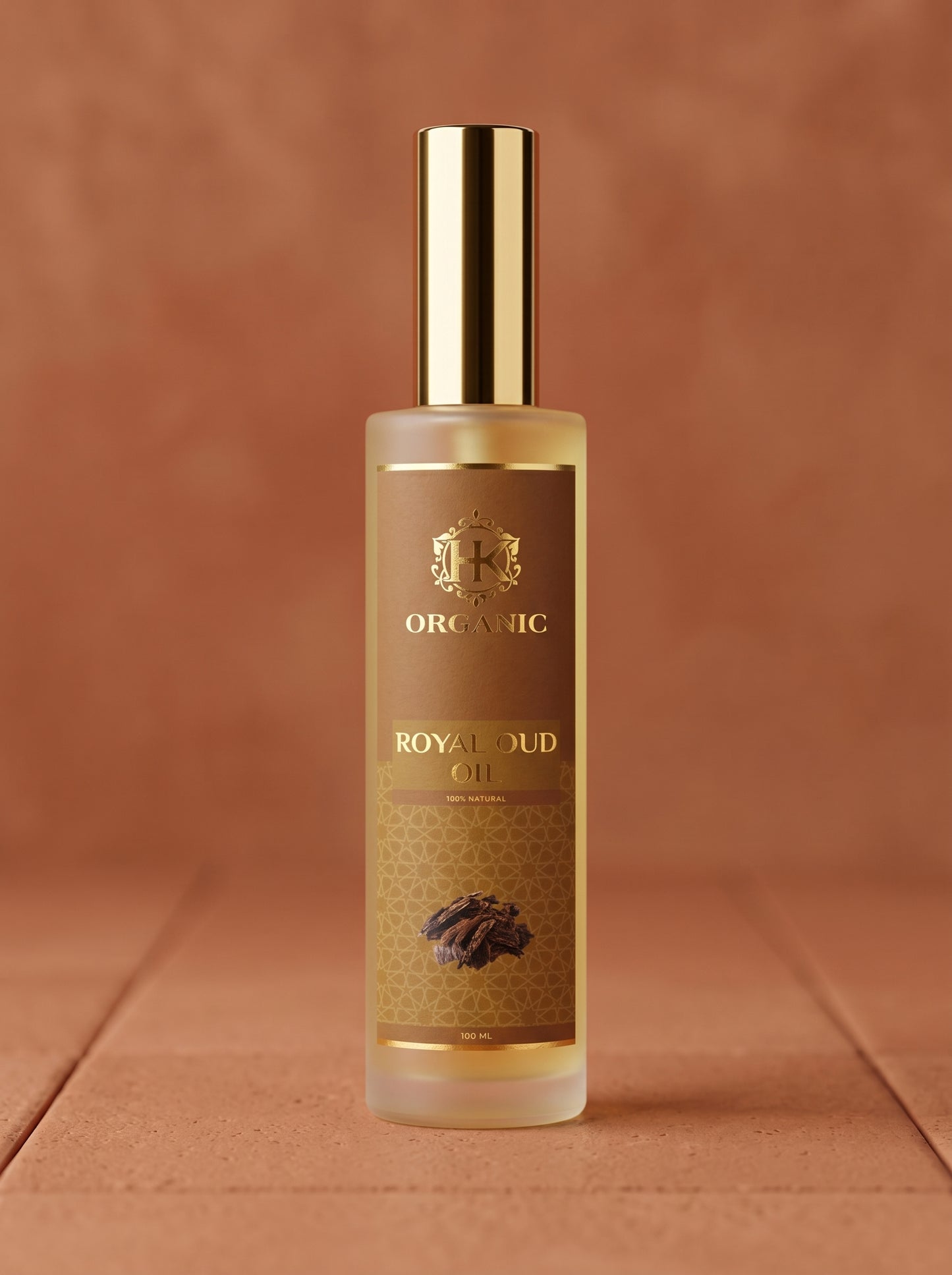 Bottle of Royal Oud oil with a gold cap on a brown background