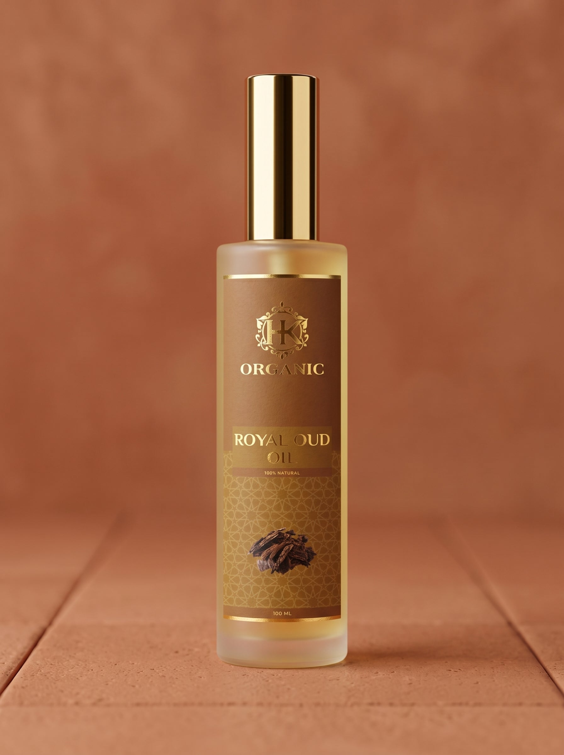 Bottle of Royal Oud oil with a gold cap on a brown background
