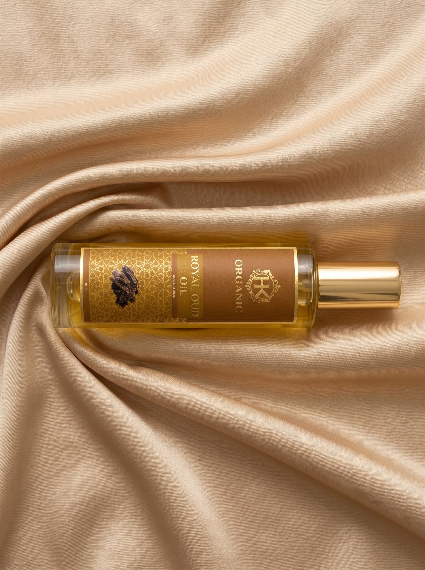 Perfume bottle with gold cap on beige fabric