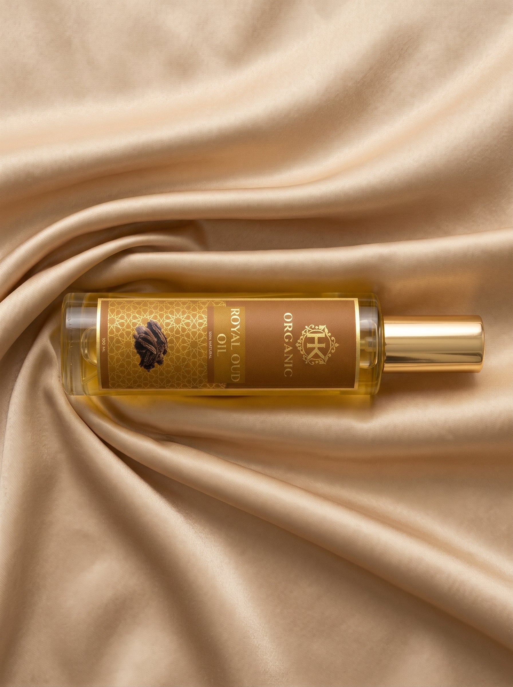Perfume bottle with gold cap on beige fabric