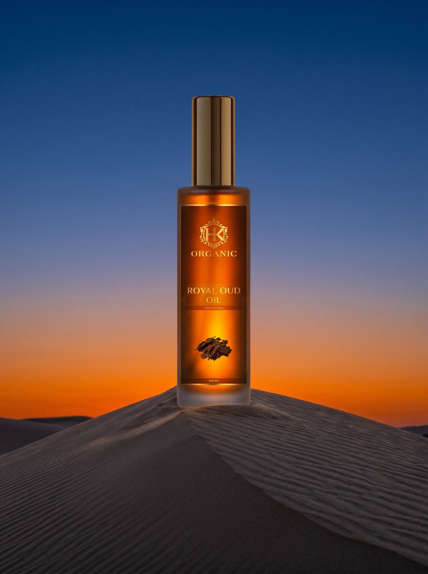 Bottle of Royal Oud oil on a sand dune with a sunset background