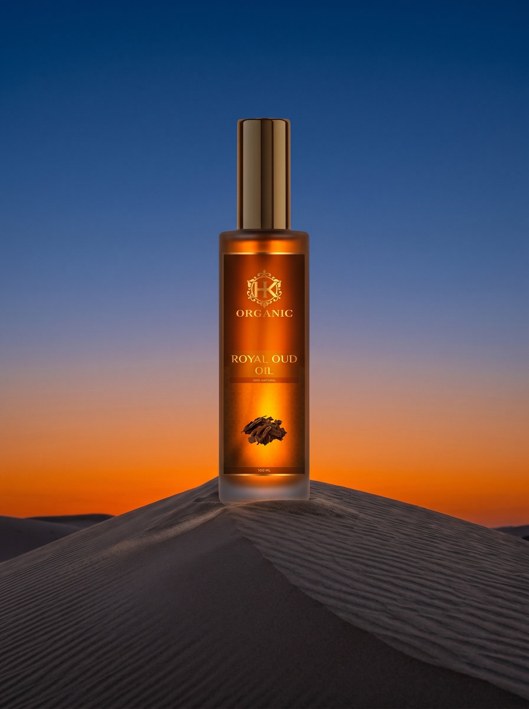 Bottle of Royal Oud oil on a sand dune with a sunset background