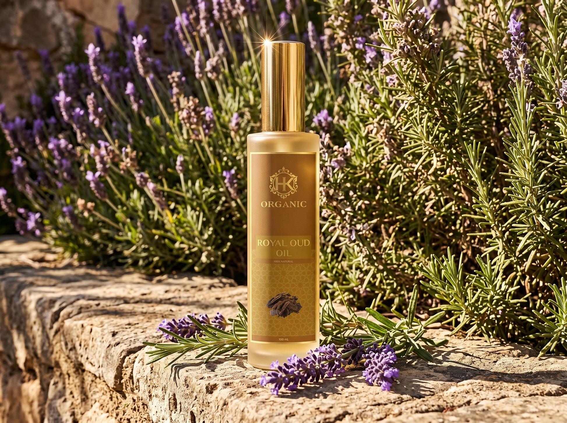 Gold bottle of organic royal oil with lavender flowers on a stone surface