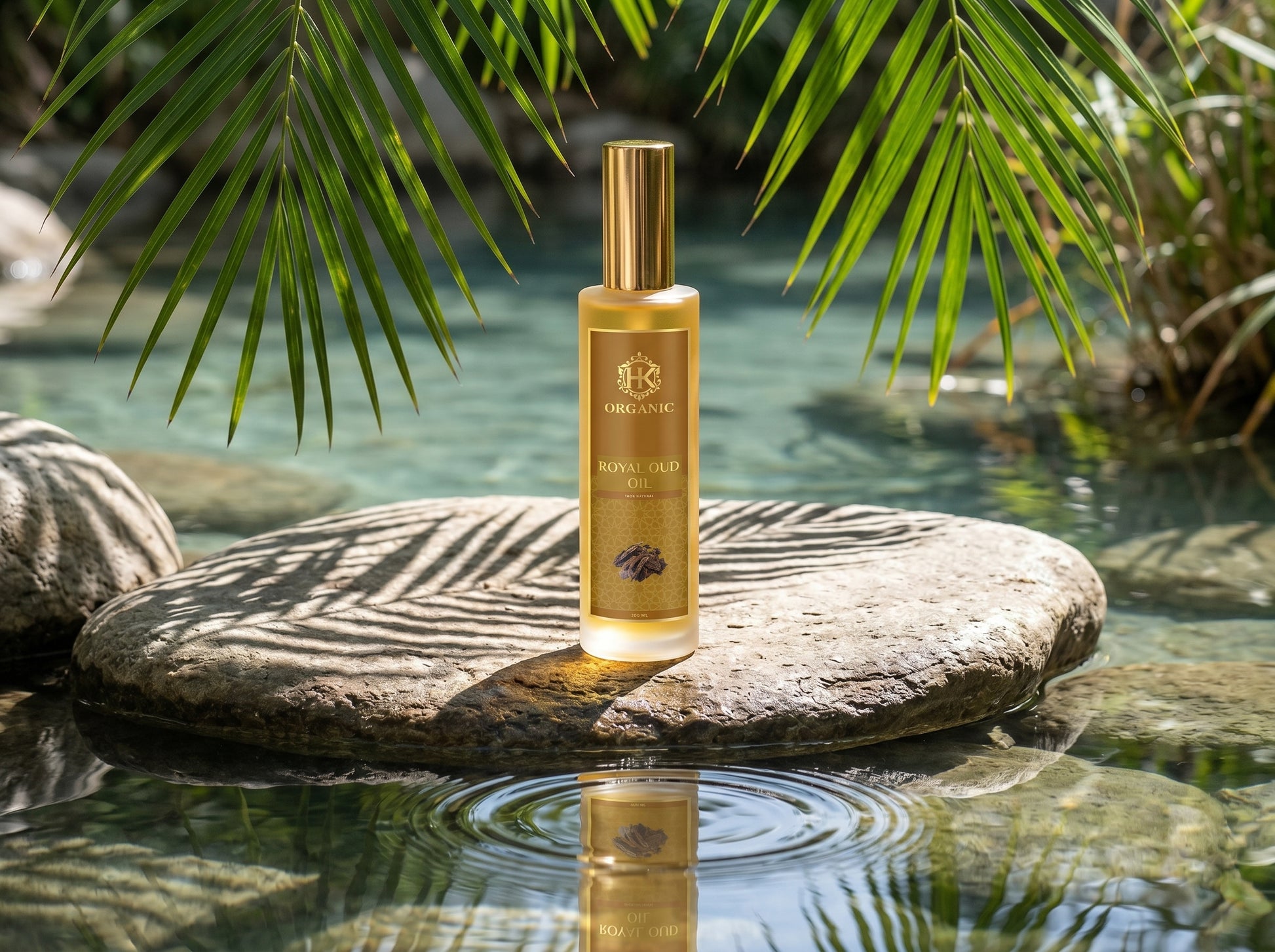 Gold bottle of perfume on a rock with water and greenery in the background