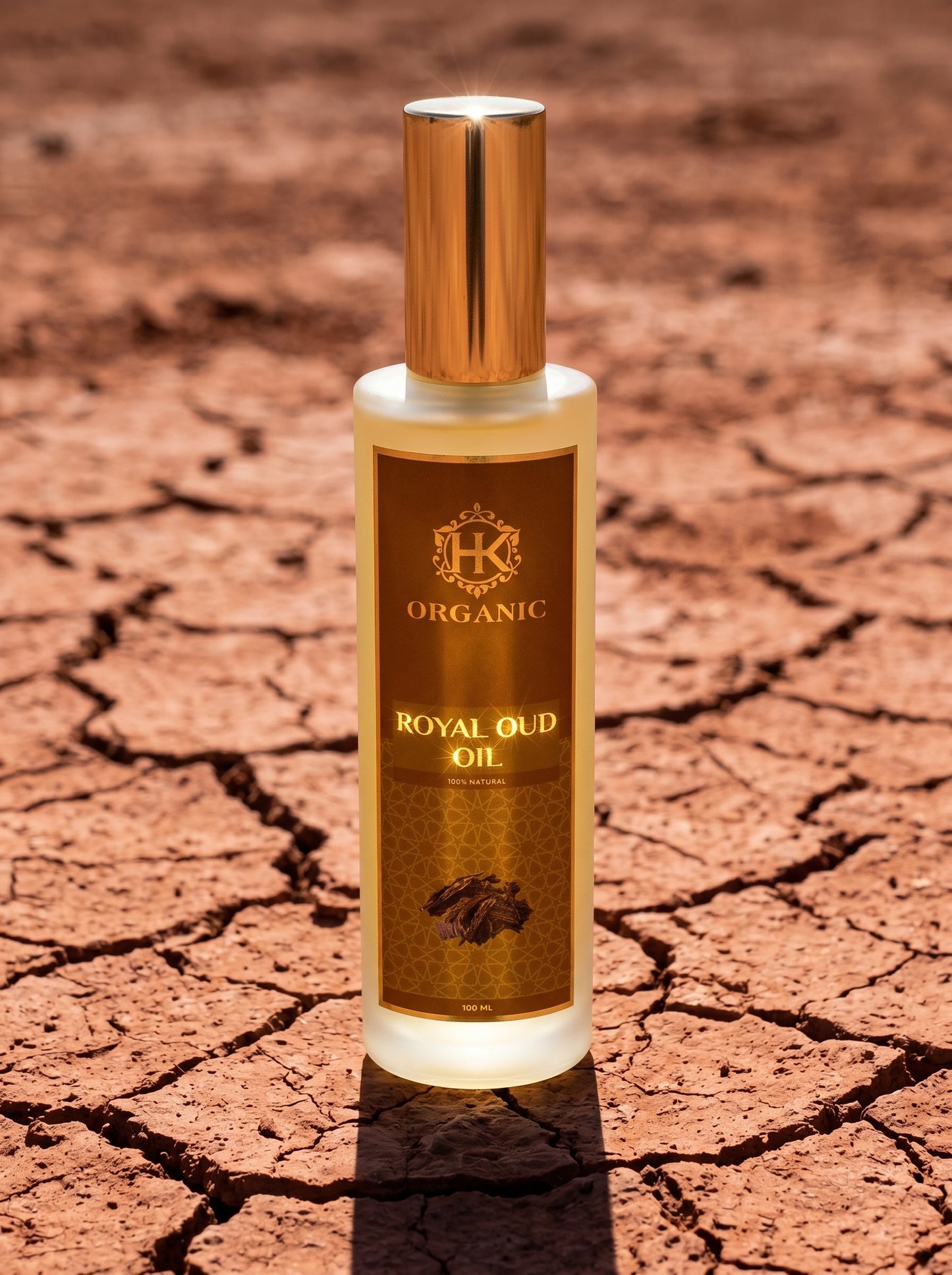 Bottle of Organic Royal Oud Oil on a cracked earth background