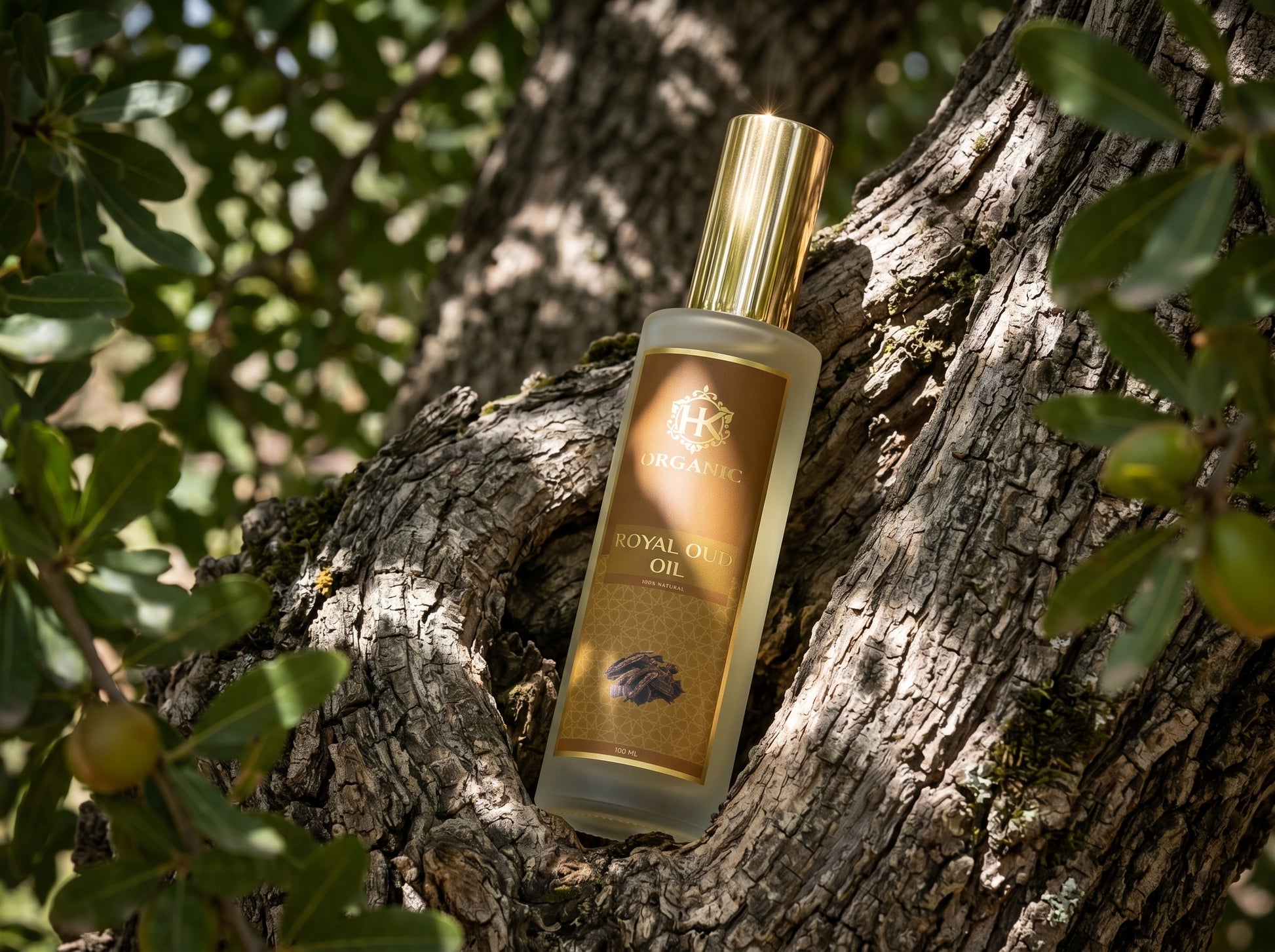 Bottle of oud Oil on a tree trunk with green leaves in the background