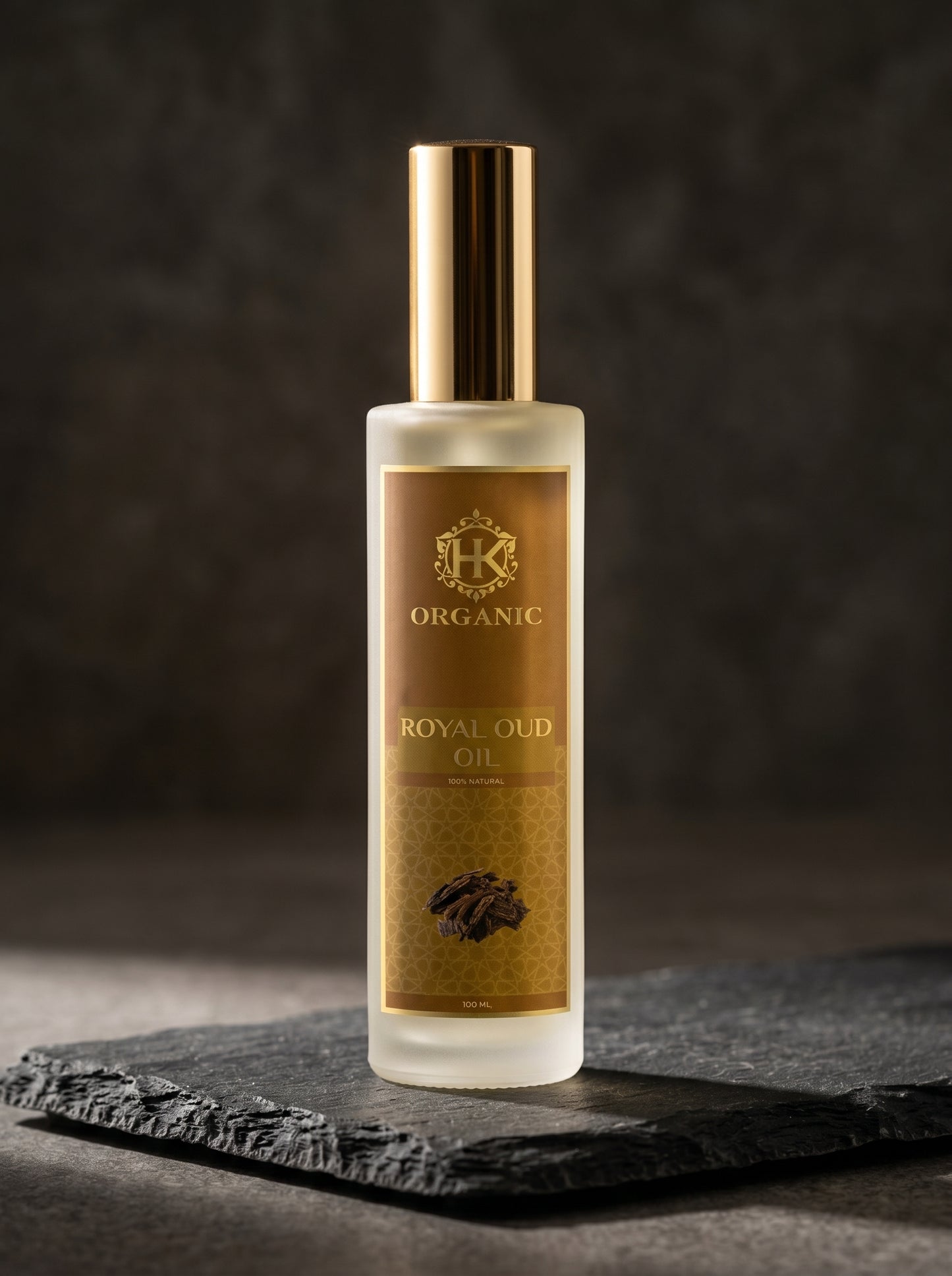 Bottle of Royal Oud oil with a gold label on a dark background
