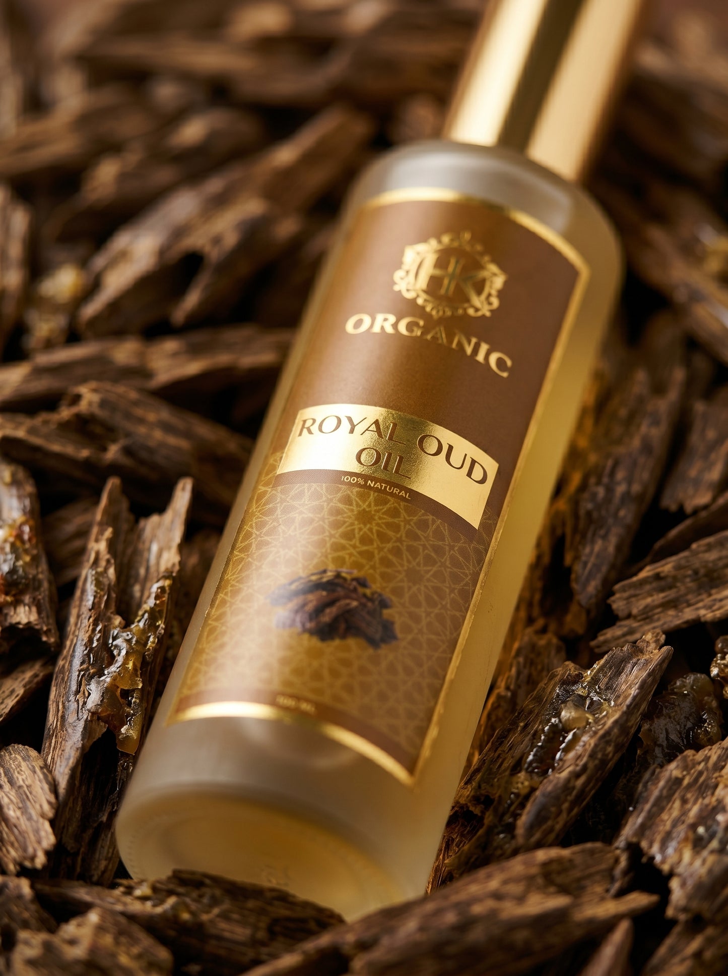 Royal Oud oil bottle on a background of dried oud wood