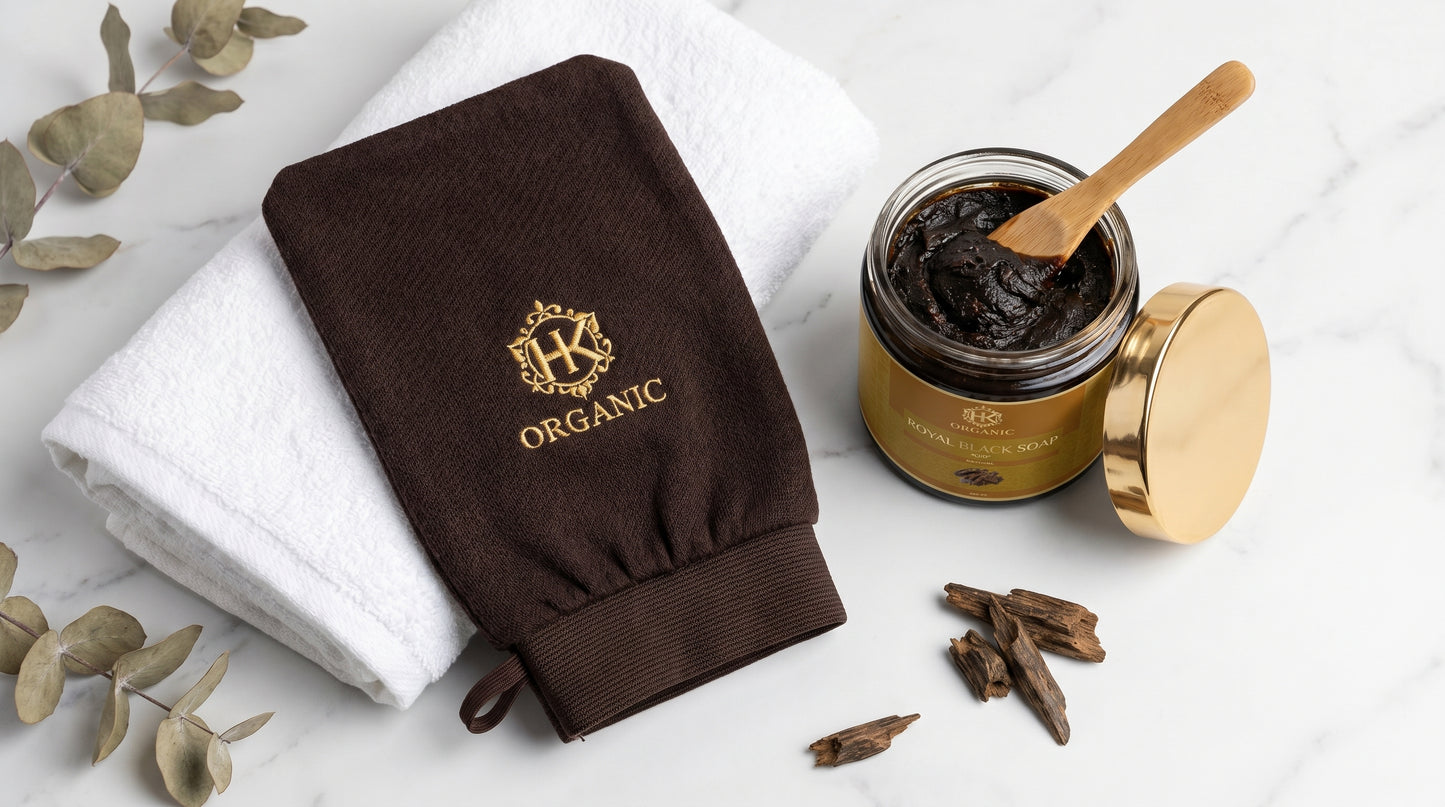 Brown organic glove and jar of cream on a white background with eucalyptus leaves.