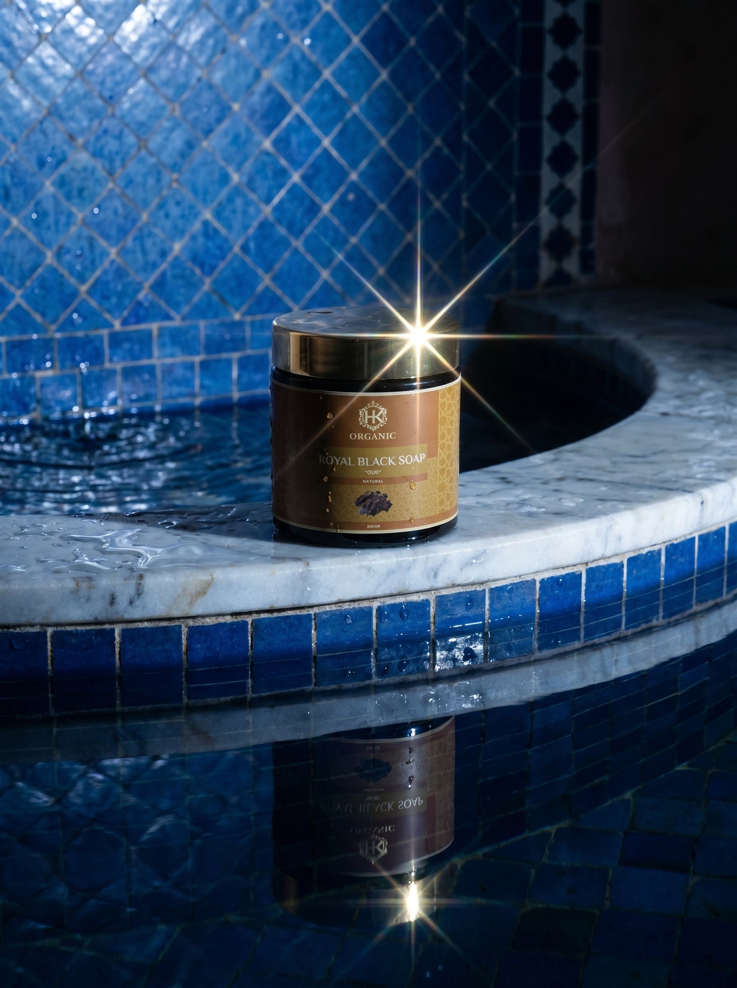 Jar of Royal Black Son on a blue tiled surface with a pool in the background