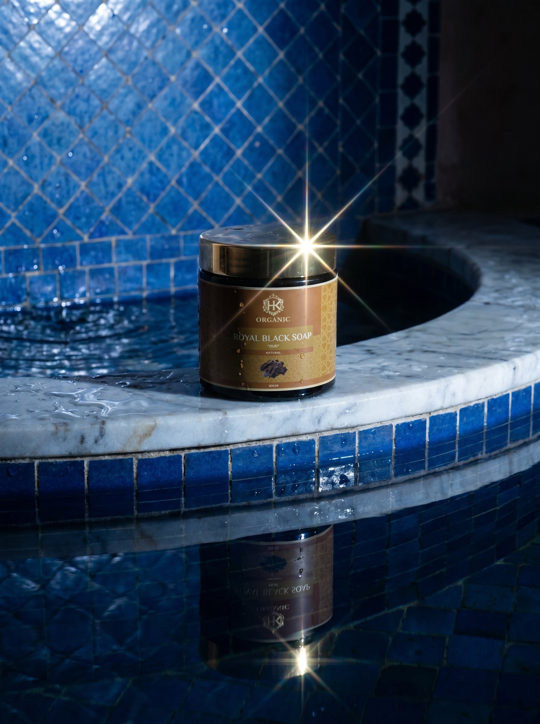 Jar of Royal Black Son on a blue tiled surface with a pool in the background