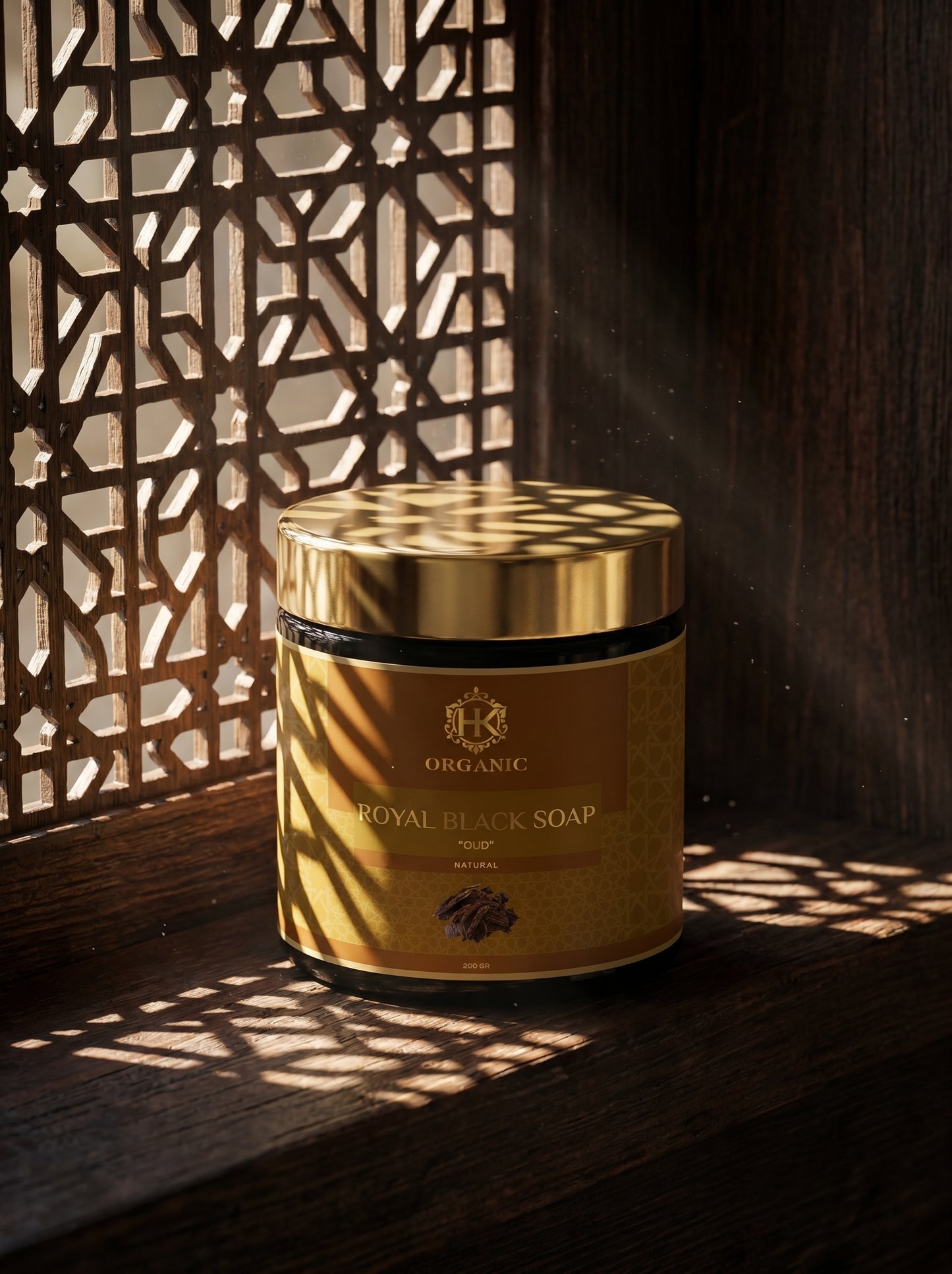 Container of Royal Black Soap with decorative shadows on a wooden surface