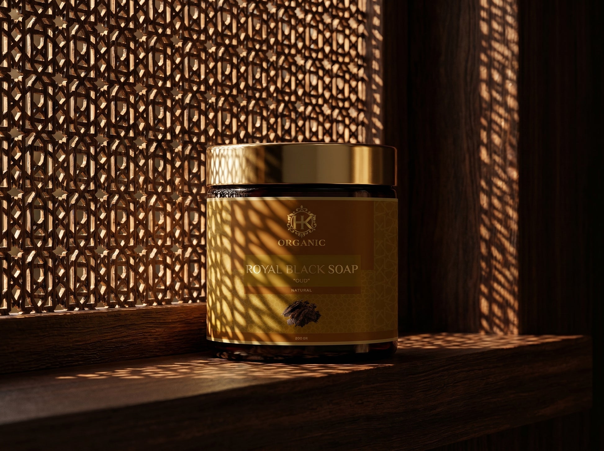 Gold jar of Royal Black Soap with a textured wall in the background