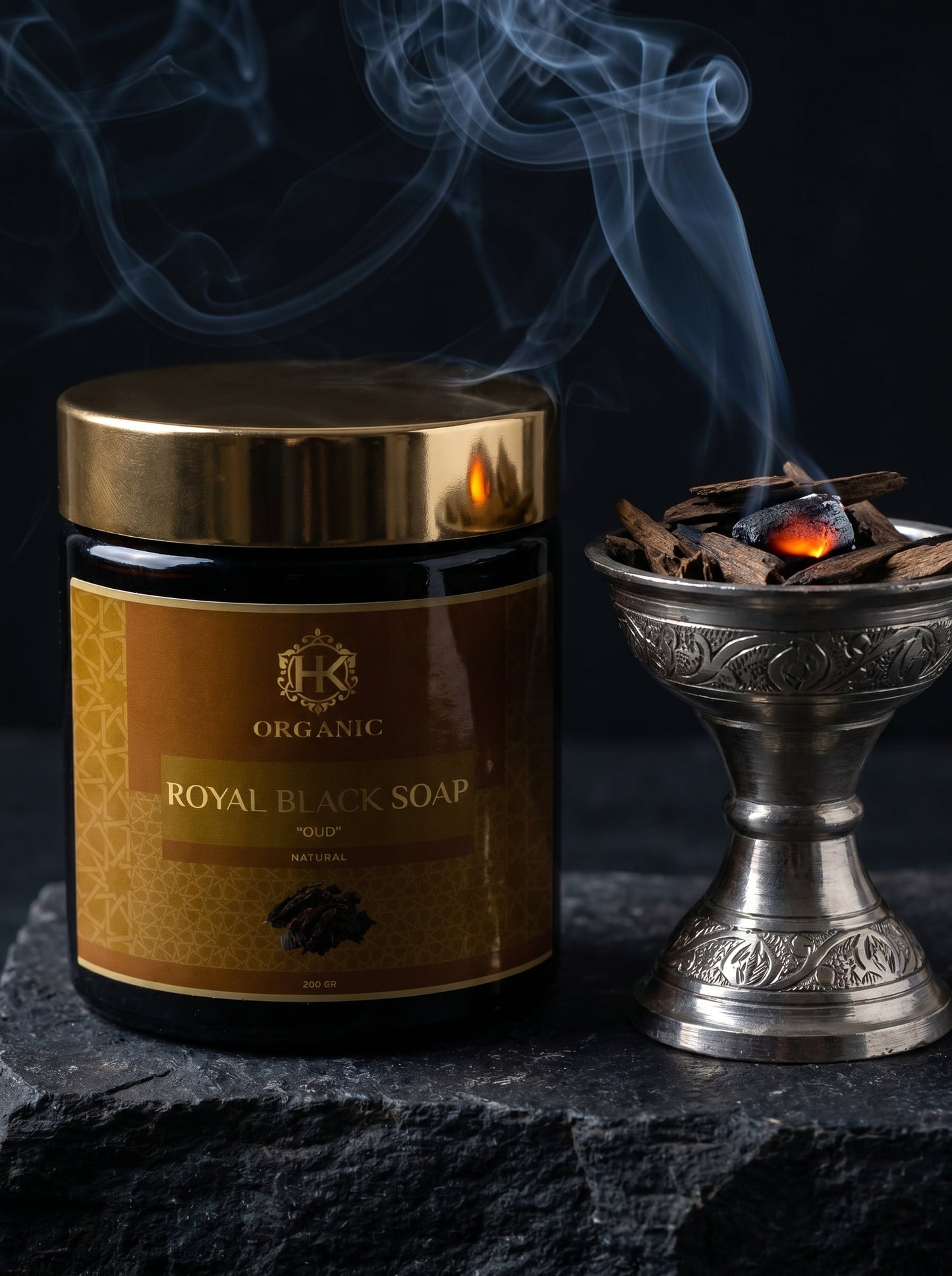 Jar of Royal Black Soap with a smoking incense holder on a dark background