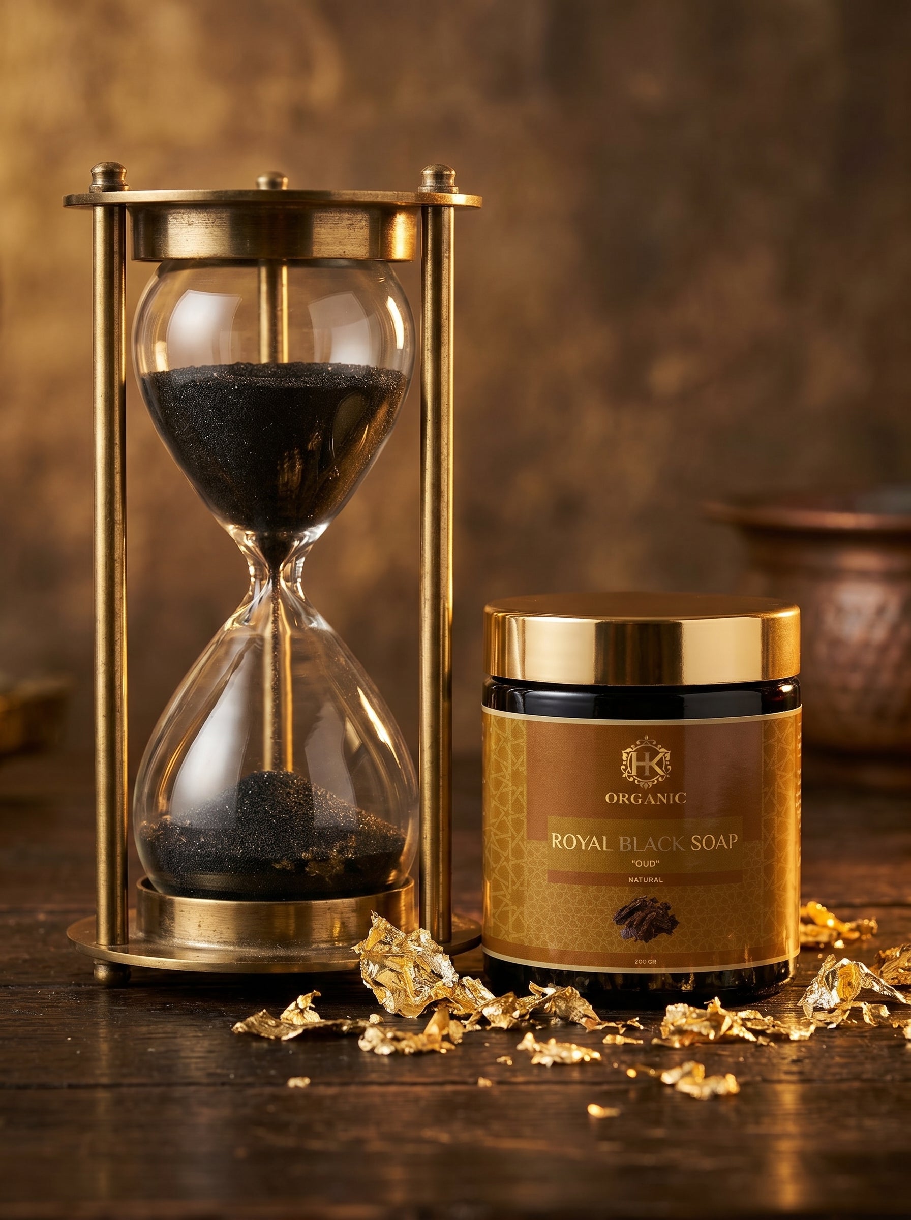 Jar of Royal Black Soap with gold lid and hourglass on a wooden surface