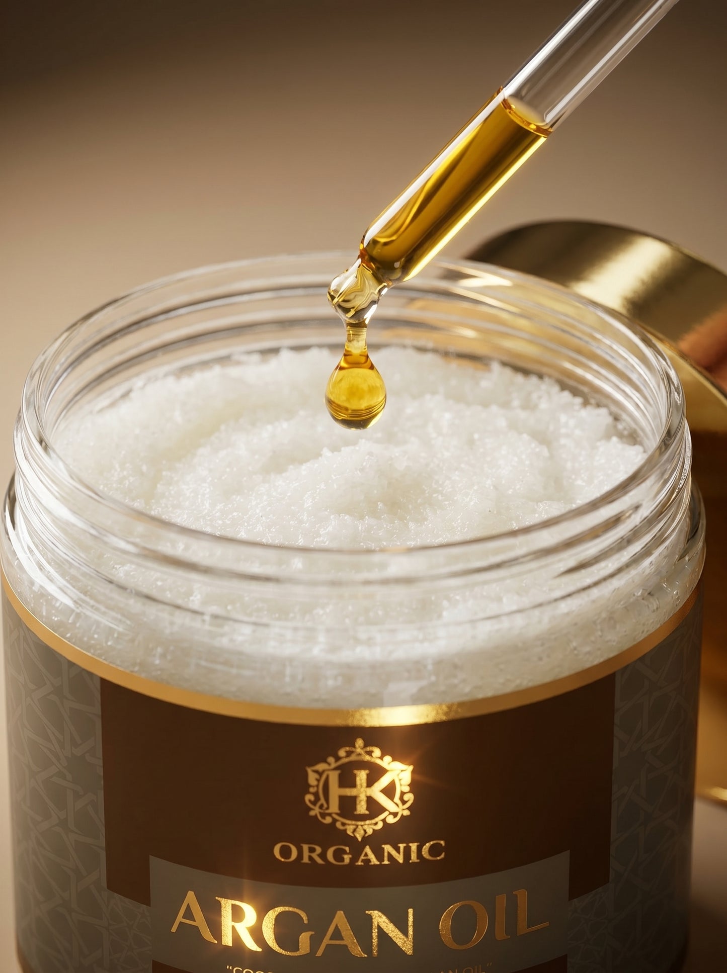 Jar of organic argan oil with a dropper dripping oil into it.