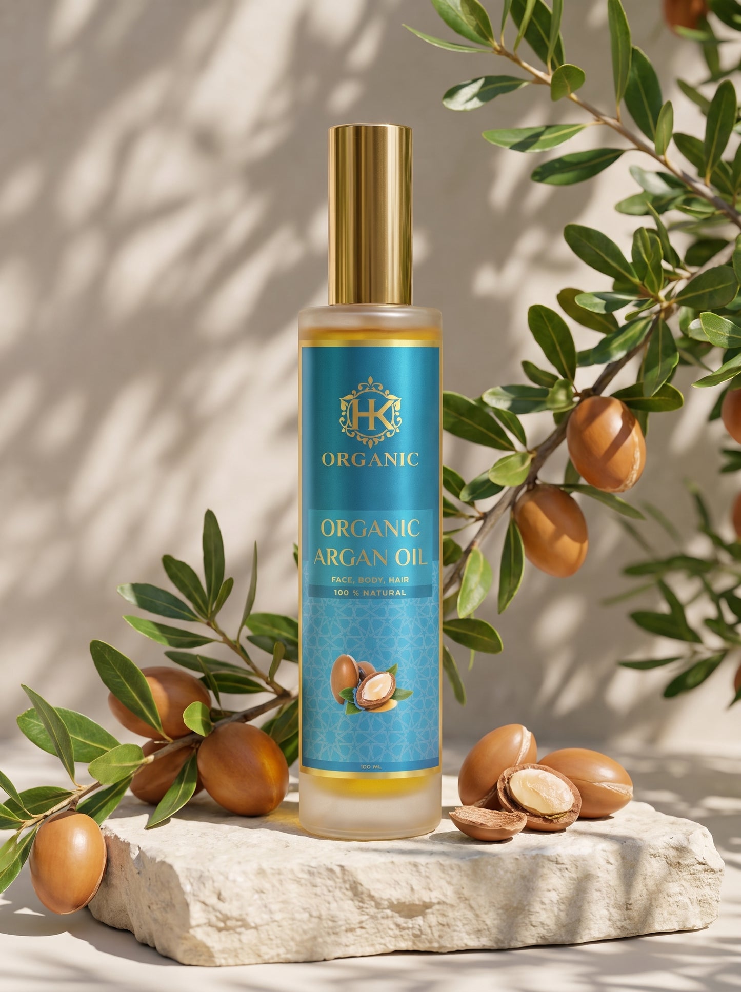 A bottle of organic argan oil with a gold cap and a blue label, styled on a stone slab with argan nuts and olive branches in warm, sunlit shadows.