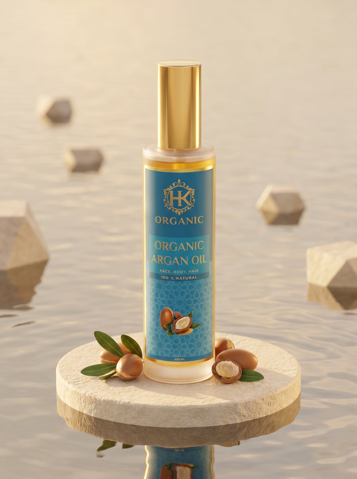 A bottle of Organic Argan Oil by HK Organic stands on a round stone pedestal. The bottle has a blue label with gold lettering and a gold cap, surrounded by argan nuts and green leaves.